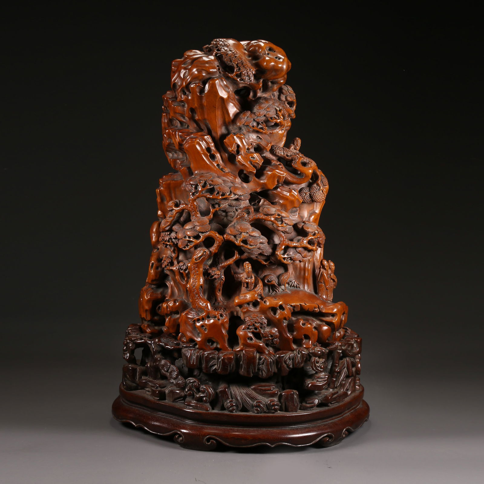 A HUANGHUALI CARVED MOUNTAIN SCULPTURE OF THE EIGHT IMMORTALS OFFERING LONGEVITY: Huanghuali carved mountain sculpture of the Eight Immortals offering longevity