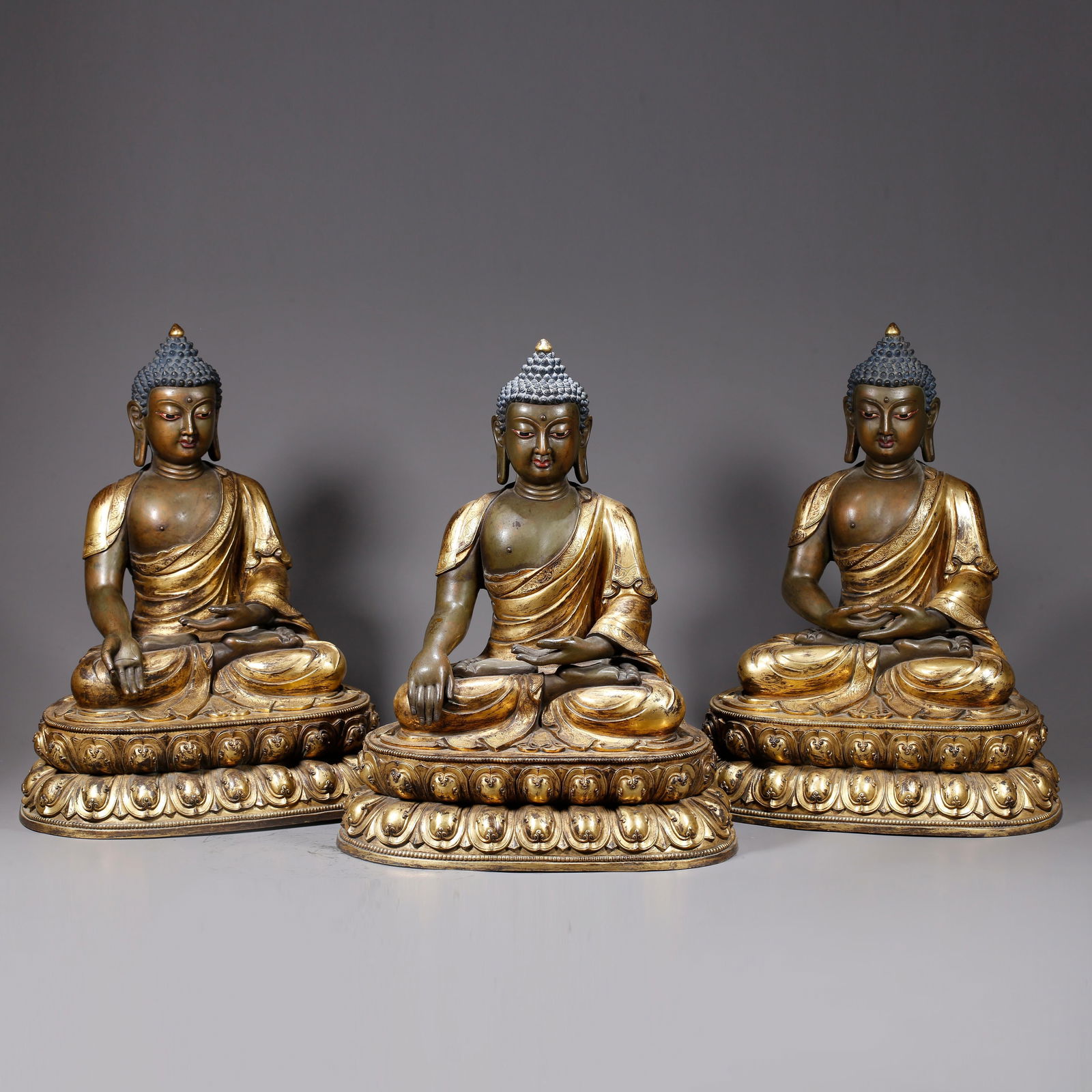 A SET OF GILT BRONZE STATUES OF SHAKYAMUNI: Set of Gilt Bronze Statues of Shakyamuni