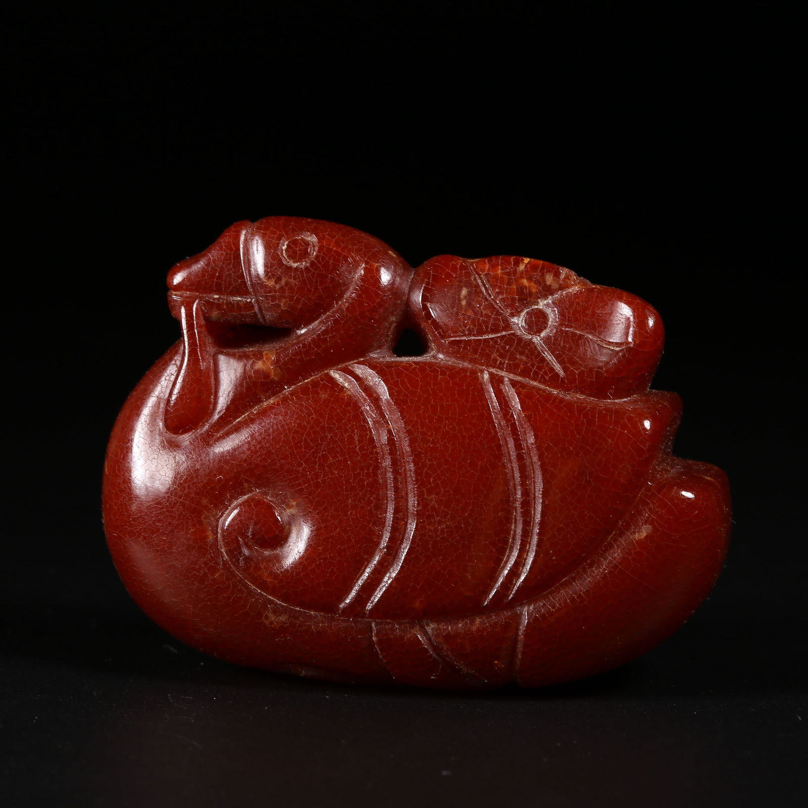 A AMBER "PRECIOUS GOOSE CARRYING A BRANCH" FIGURINE: Amber "Precious Goose Carrying a Branch" figurine