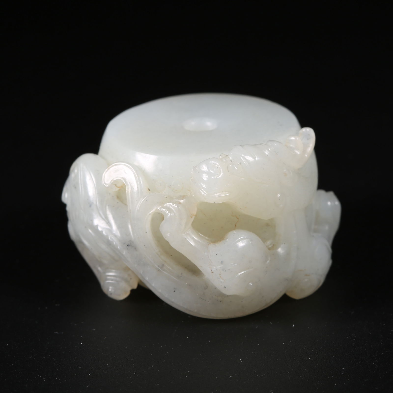 A HETIAN JADE DRUM-SHAPED PENDANT WITH CHI-DRAGON DESIGN: Hetian jade drum-shaped pendant with chi-dragon design