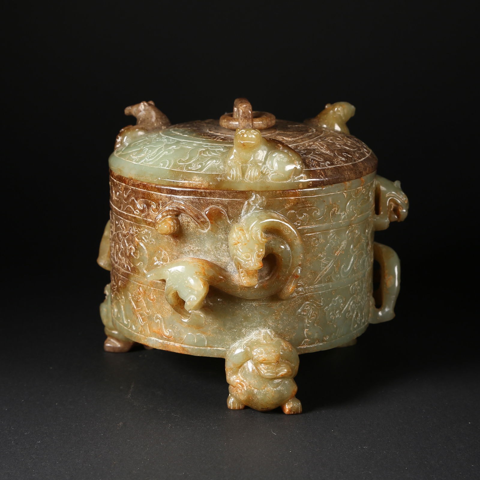 A HETIAN JADE COVERED JAR WITH THREE BEAST-FORM LEGS, MOVABLE RINGS, AND RELIEF-CARVED DRAGON: Hetian jade covered jar with three beast-form legs, movable rings, and relief-carved dragon