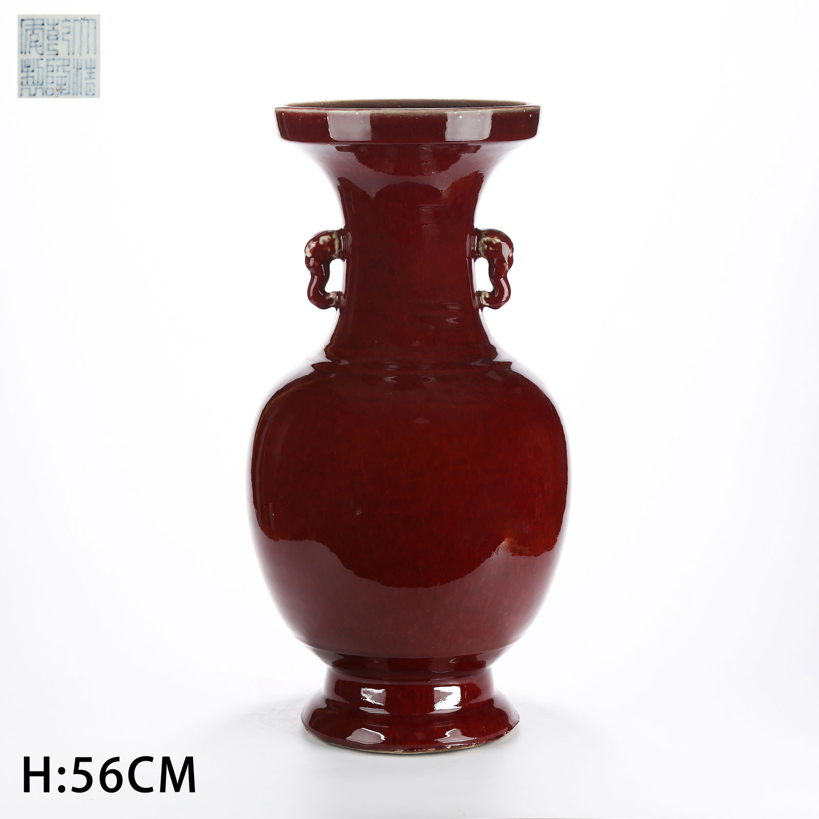 A RED-GLAZED VASE WITH ELEPHANT-HEAD HANDLES AND EVERTED RIM: Red-Glazed Vase with Elephant-Head Handles and Everted Rim
