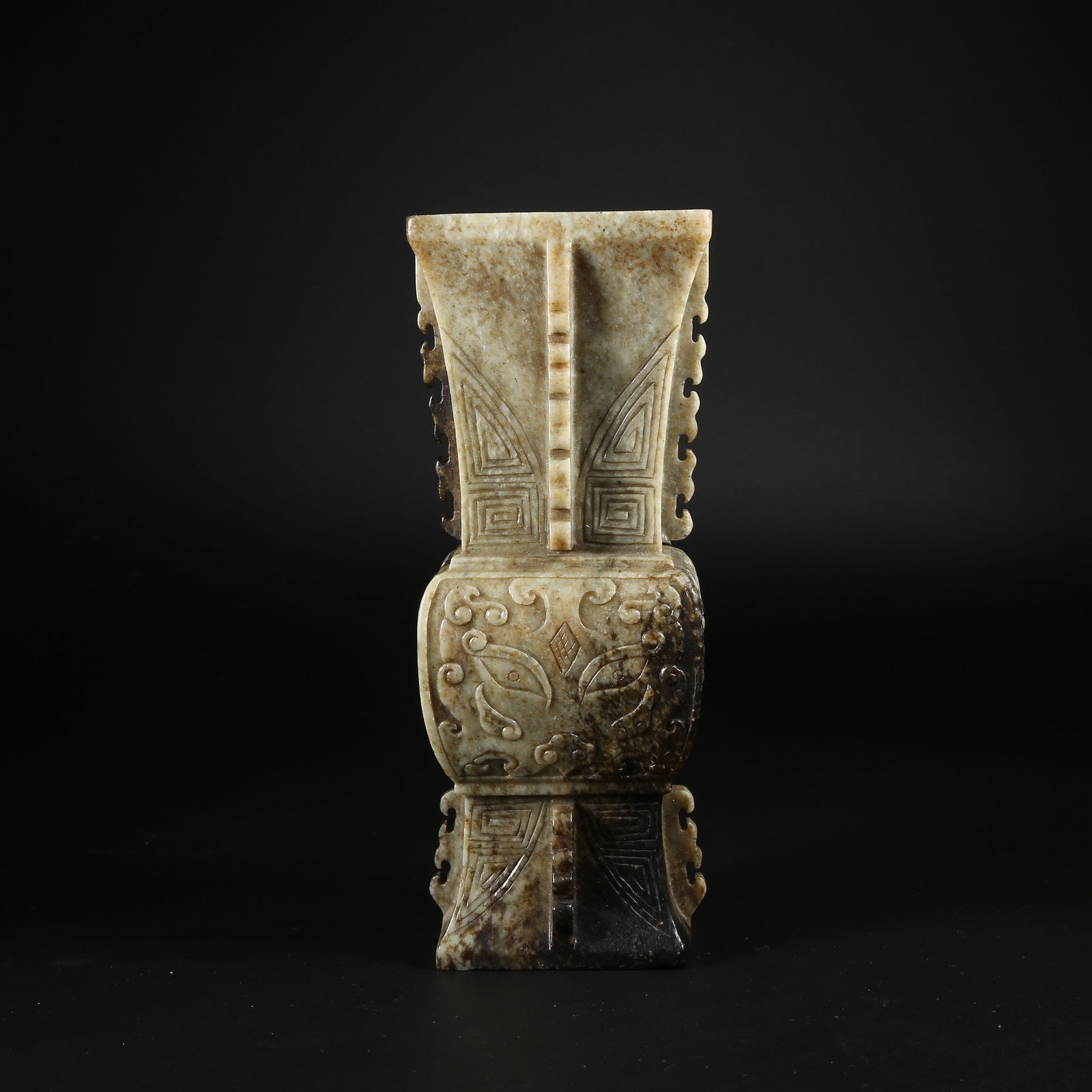 A HETIAN JADE FLOWER GU WITH BEAST-FACE MOTIF: Hetian jade flower gu with beast-face motif