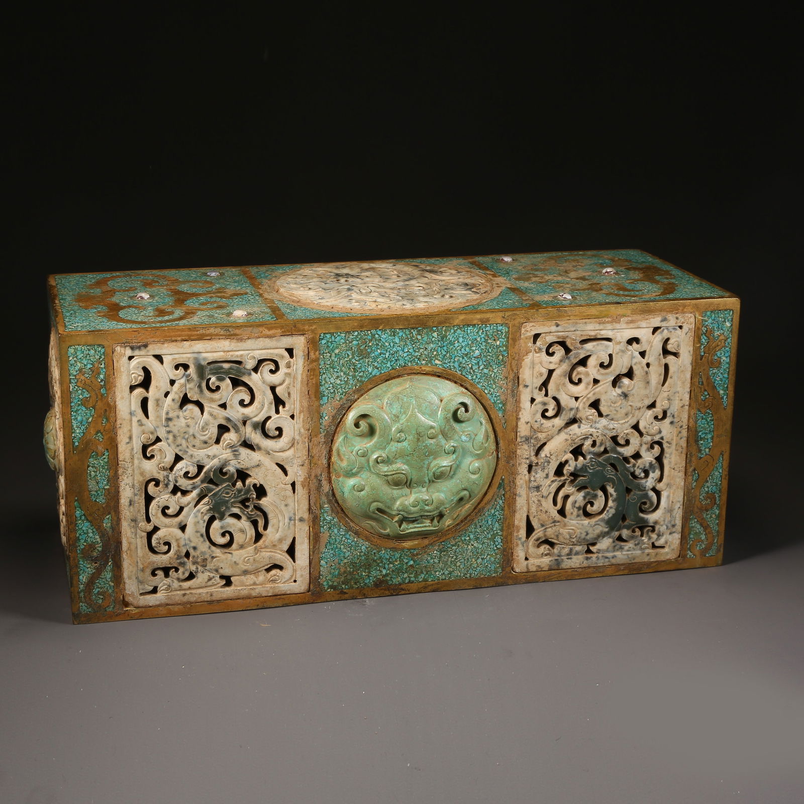 A GILDED BRONZE PILLOW INLAID WITH ANCIENT JADE TUANLONG PATTERN: Gilded bronze pillow inlaid with ancient jade tuanlong pattern
