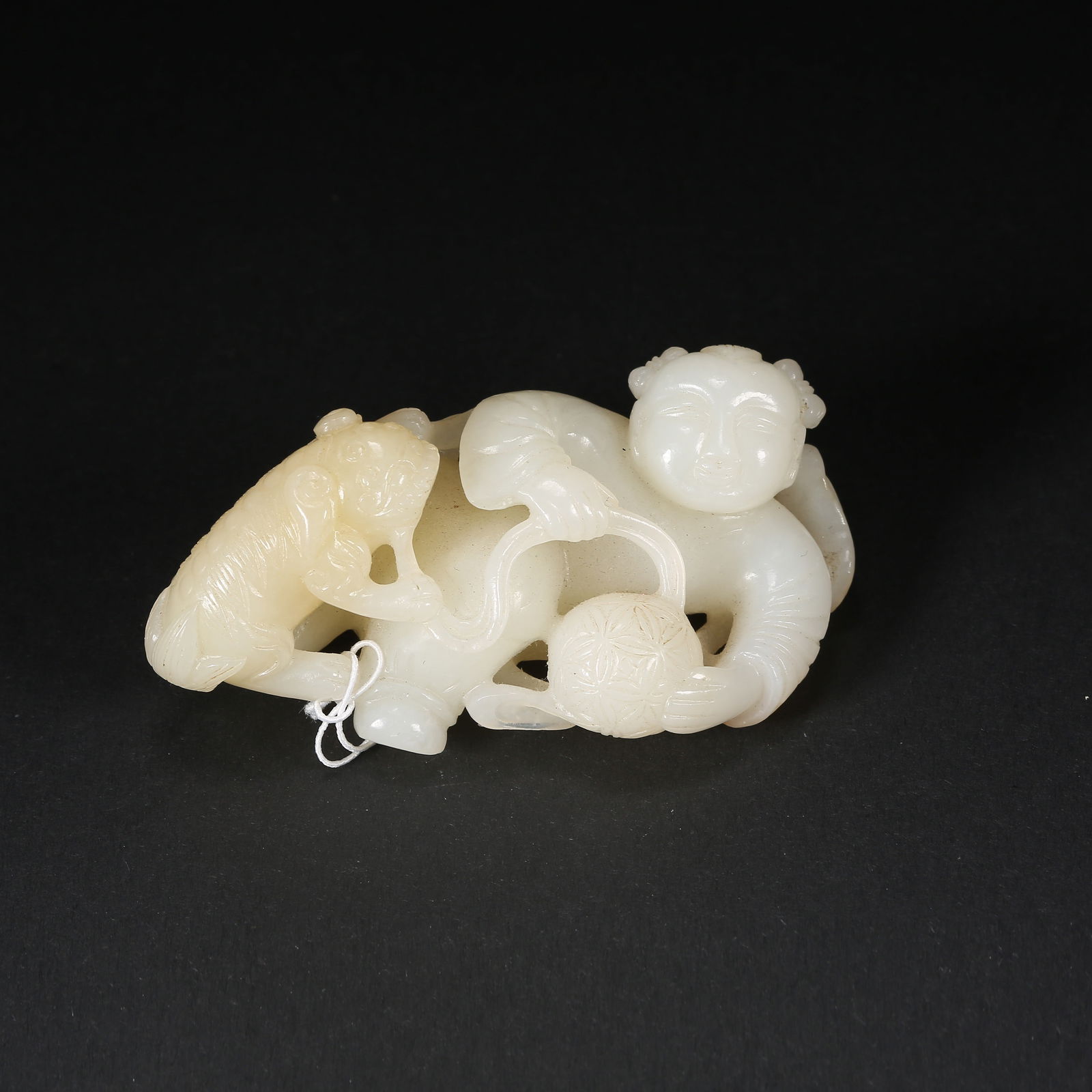 A HETIAN JADE CHILD-PLAYING-WITH-BEAST PALM PIECE: Hetian jade child-playing-with-beast palm piece