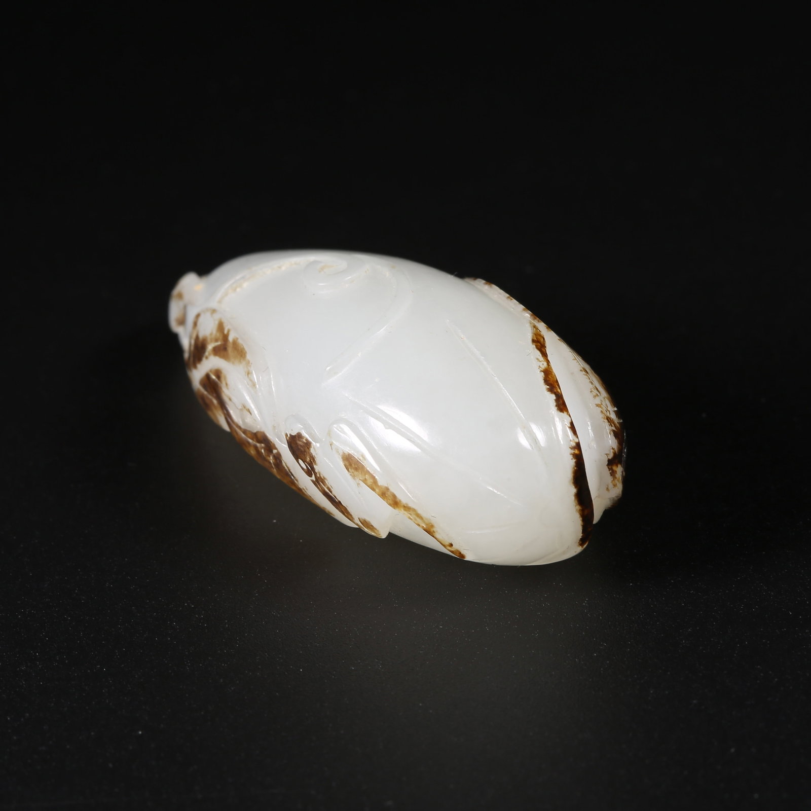 A HETIAN WHITE JADE "BLESSED GOURD" PENDANT WITH PRESERVED SKIN: Hetian white jade "Blessed Gourd" pendant with preserved skin