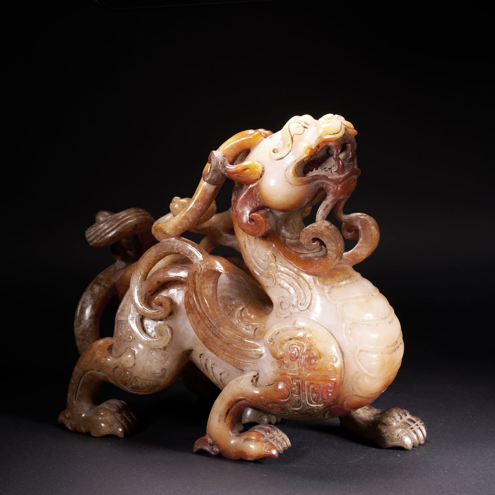 A HETIAN JADE AUSPICIOUS BEAST ORNAMENT, HAN DYNASTY: Hetian jade auspicious beast ornament, Han Dynasty