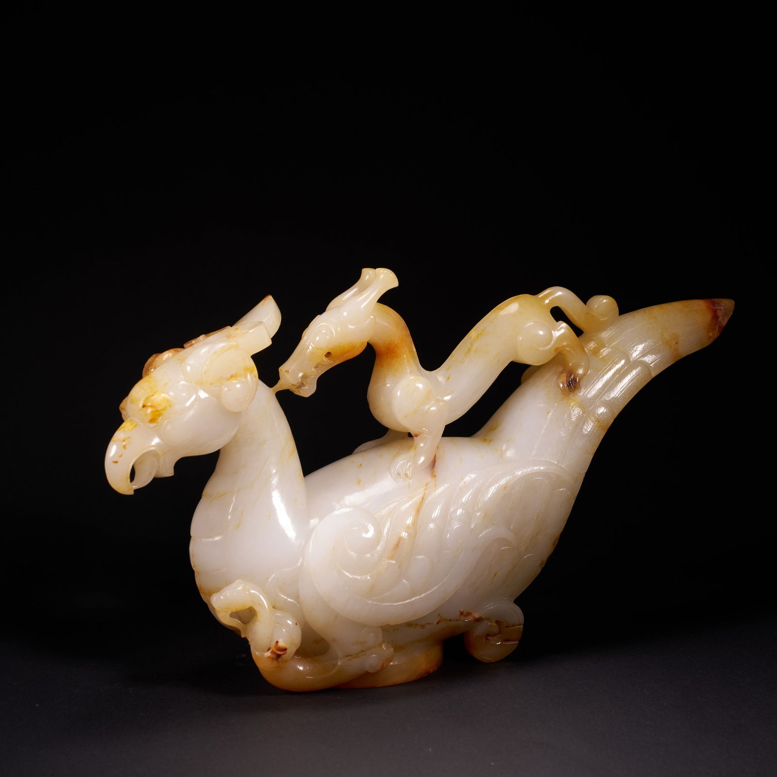 A HETIAN JADE "FOUR DIVINE CREATURES" ORNAMENT, HAN DYNASTY (1 of 8)