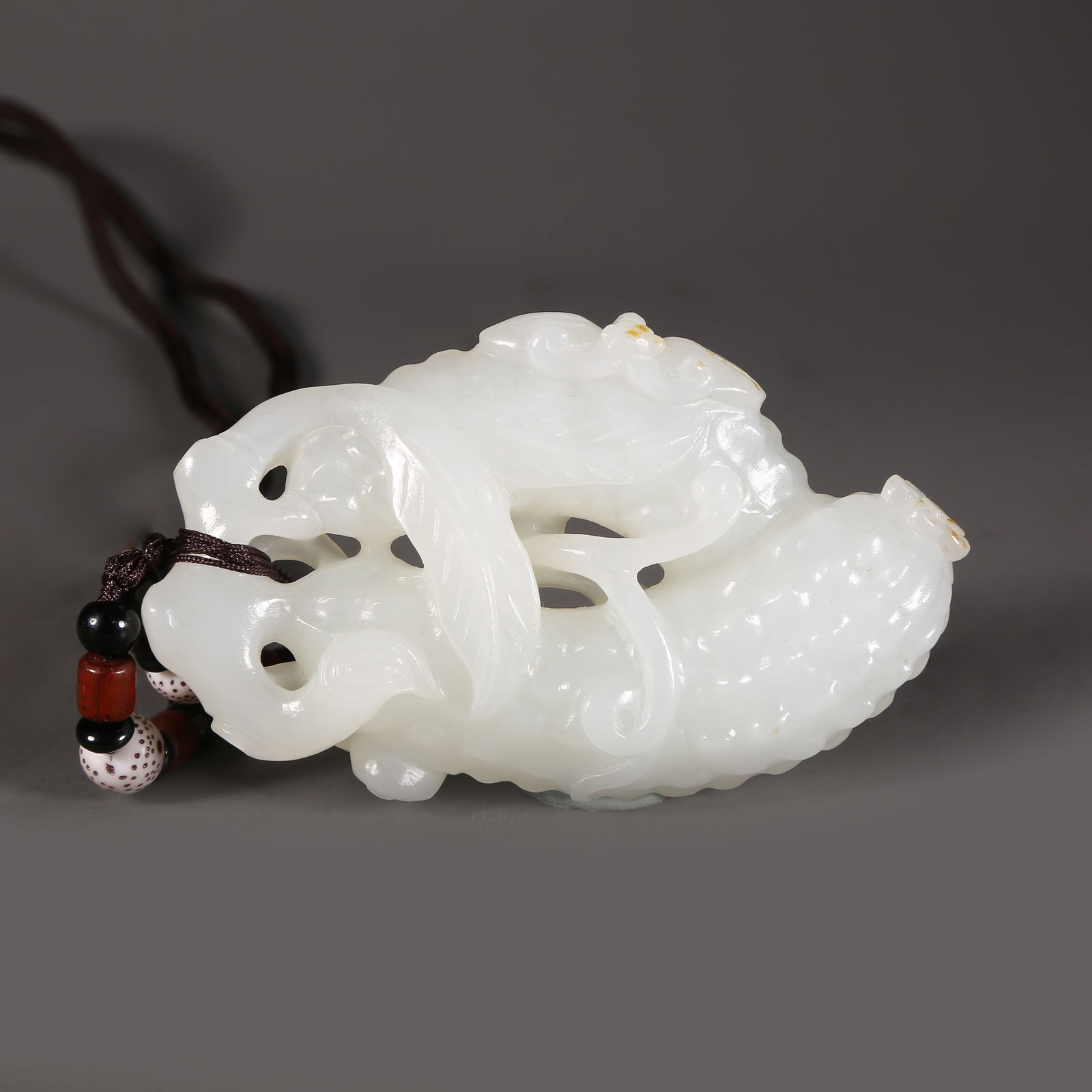 A HETIAN JADE AUSPICIOUS FRUIT PENDANT (1 of 8)