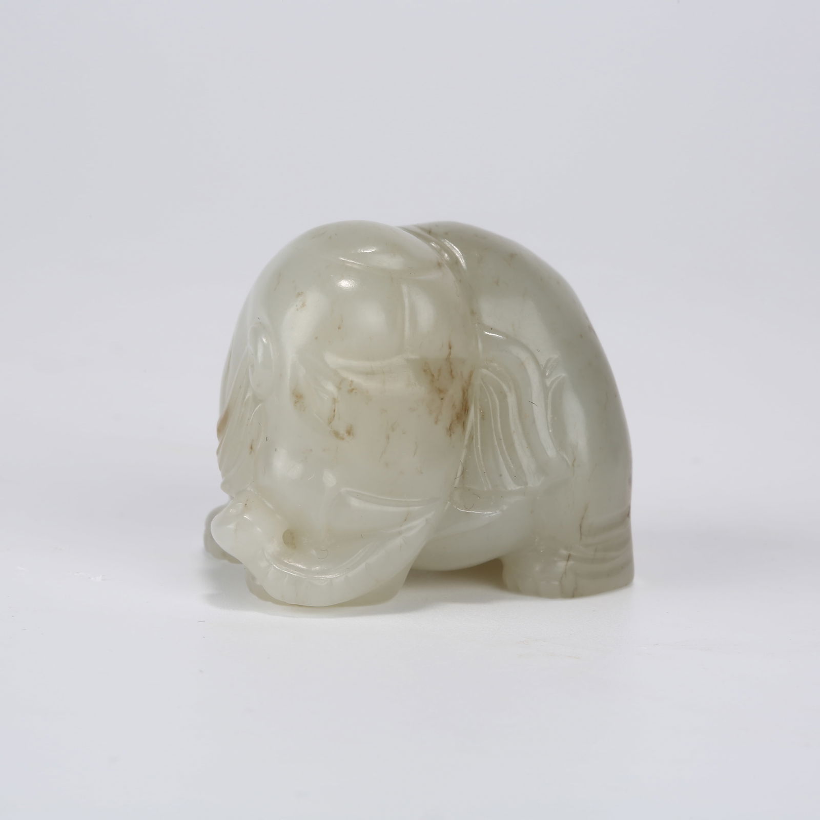 A HETIAN WHITE JADE "PEACE AND PROSPERITY" ELEPHANT ORNAMENT: Hetian White Jade "Peace and Prosperity" Elephant Ornament