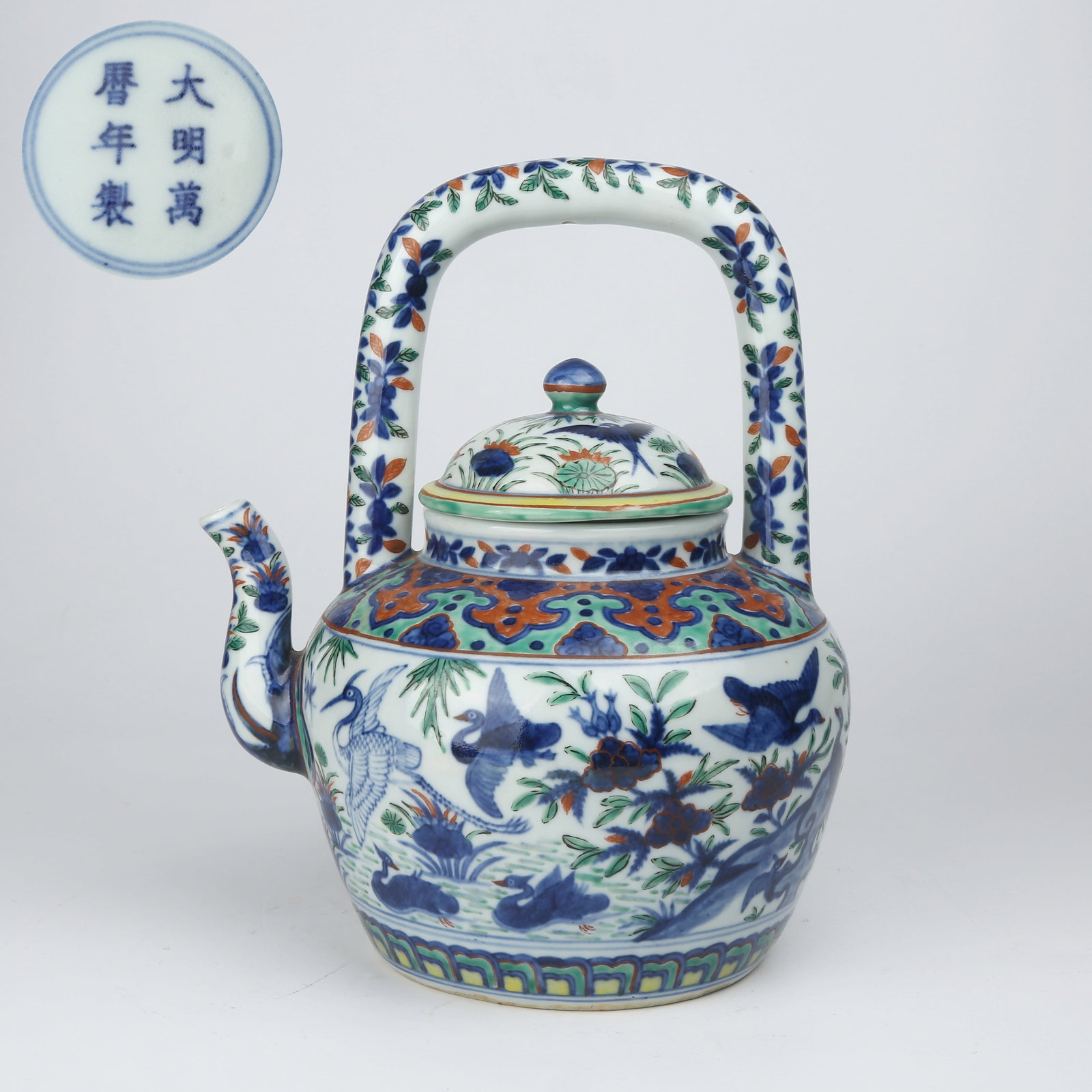 A BLUE-AND-WHITE AND WUCAI HANDLED TEAPOT (1 of 9)