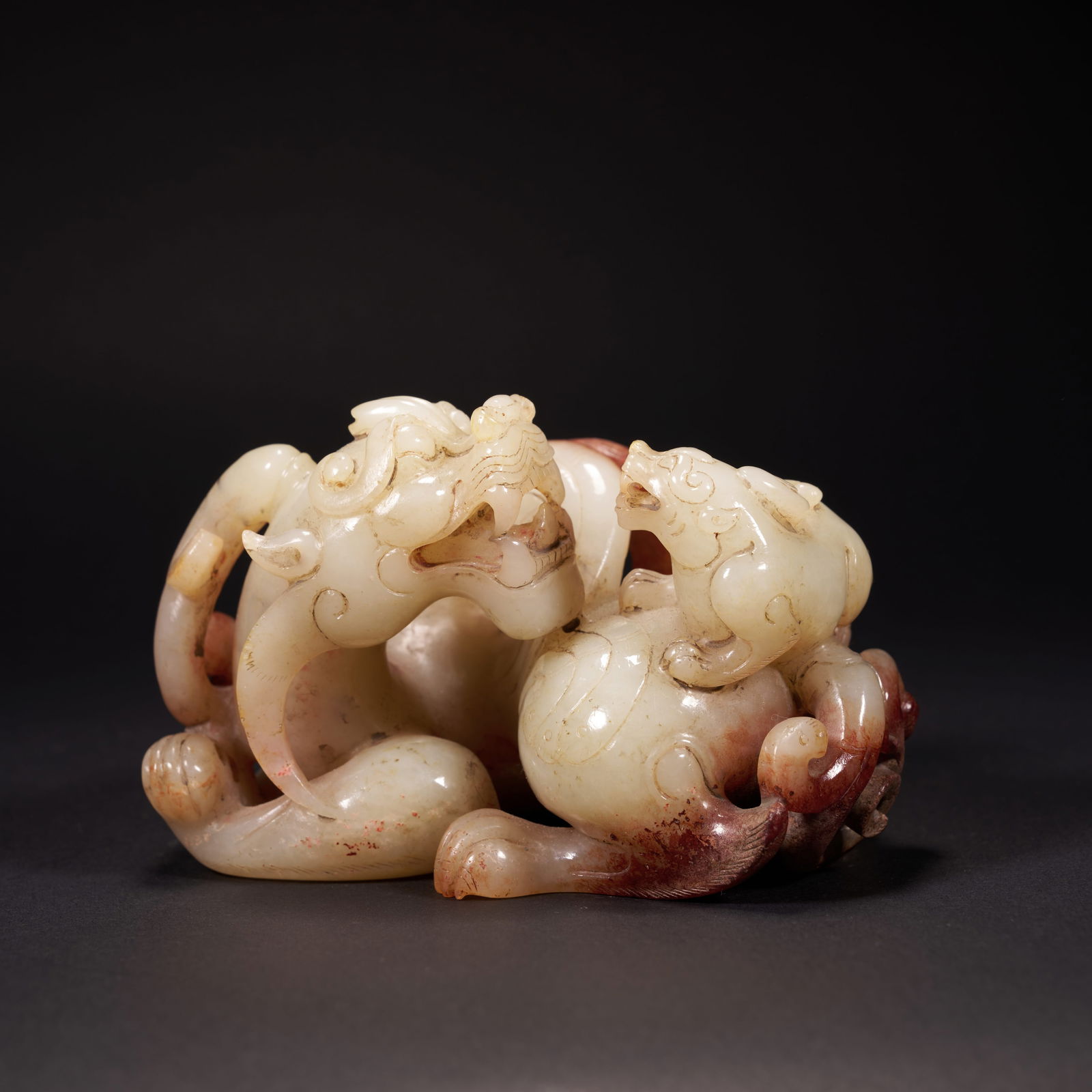 A HETIAN JADE "MOTHER-AND-CHILD BEAST" ORNAMENT, HAN DYNASTY: Hetian jade "Mother-and-Child Beast" ornament, Han Dynasty