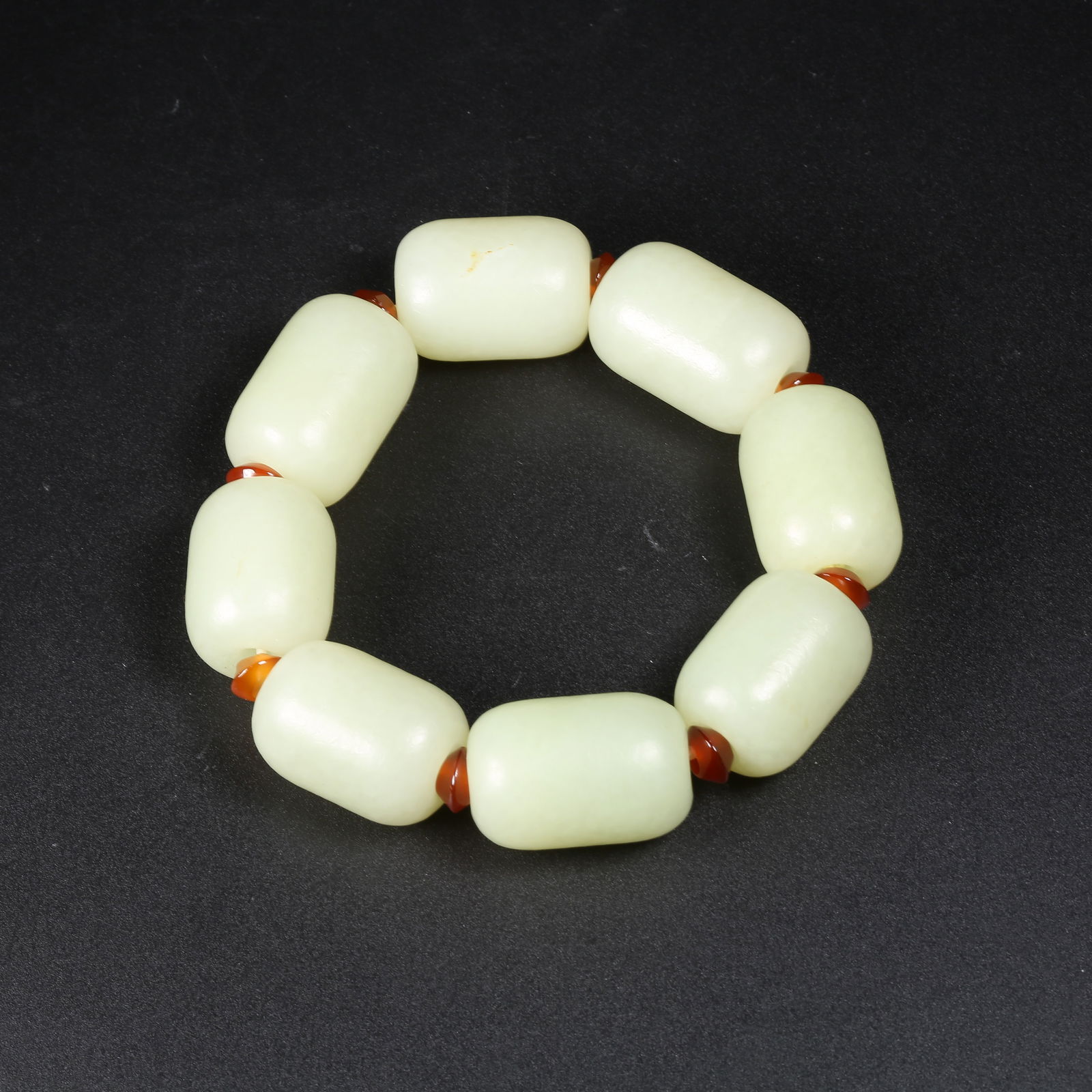 A HETIAN JADE HAND-STRUNG BRACELET (1 of 7)