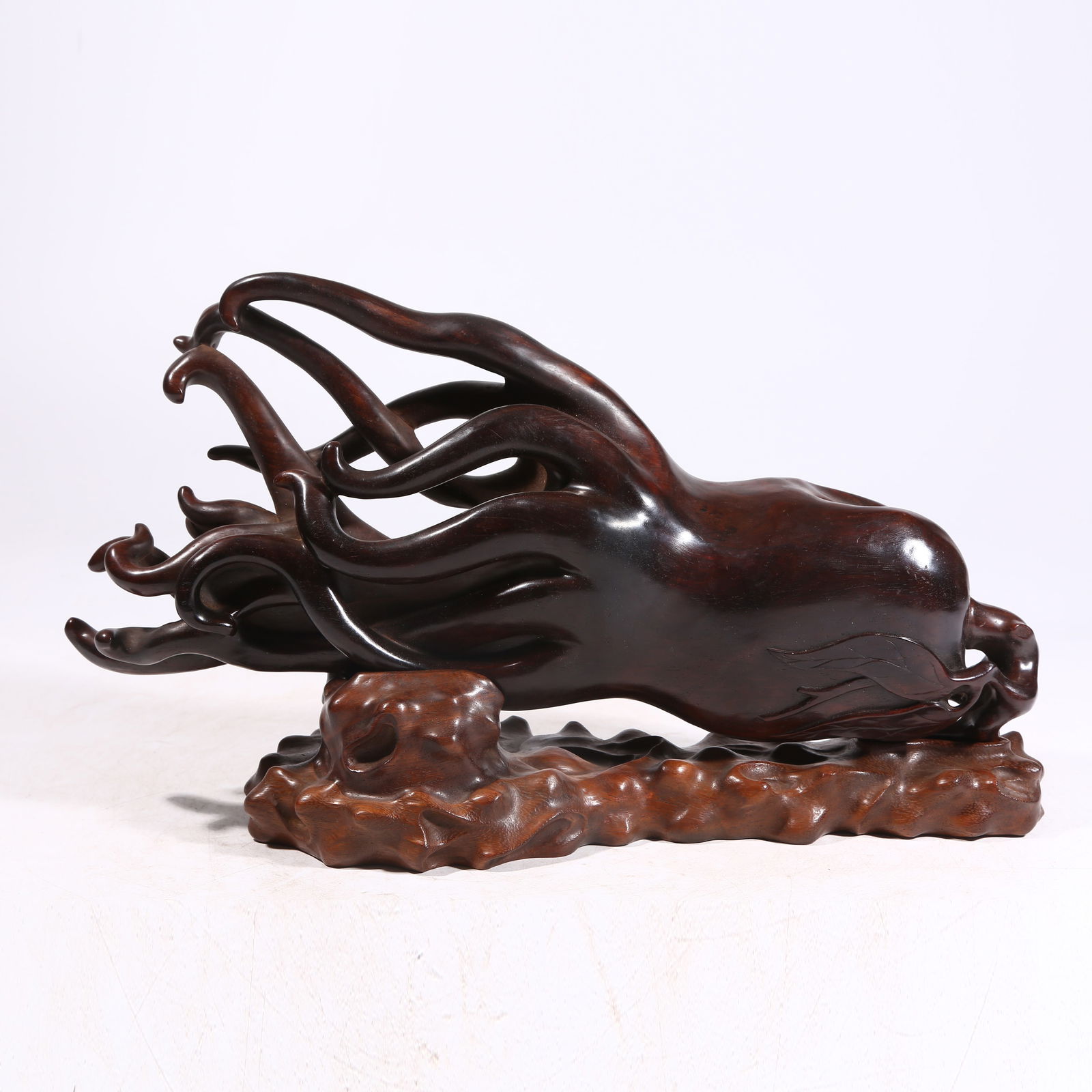 A HUANGHUALI WOOD PENDANT SHAPED LIKE BUDDHA’S HAND (1 of 8)