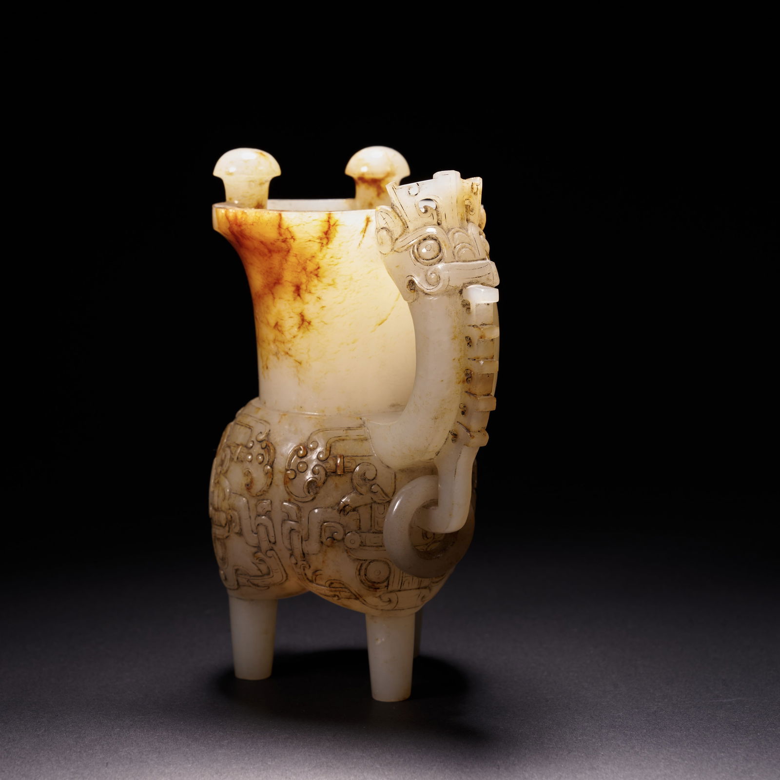 A HETIAN JADE THREE-LEGGED HORN-SHAPED CUP WITH DRAGON HANDLE AND MOVABLE RINGS, HAN DYNASTY (1 of 7)