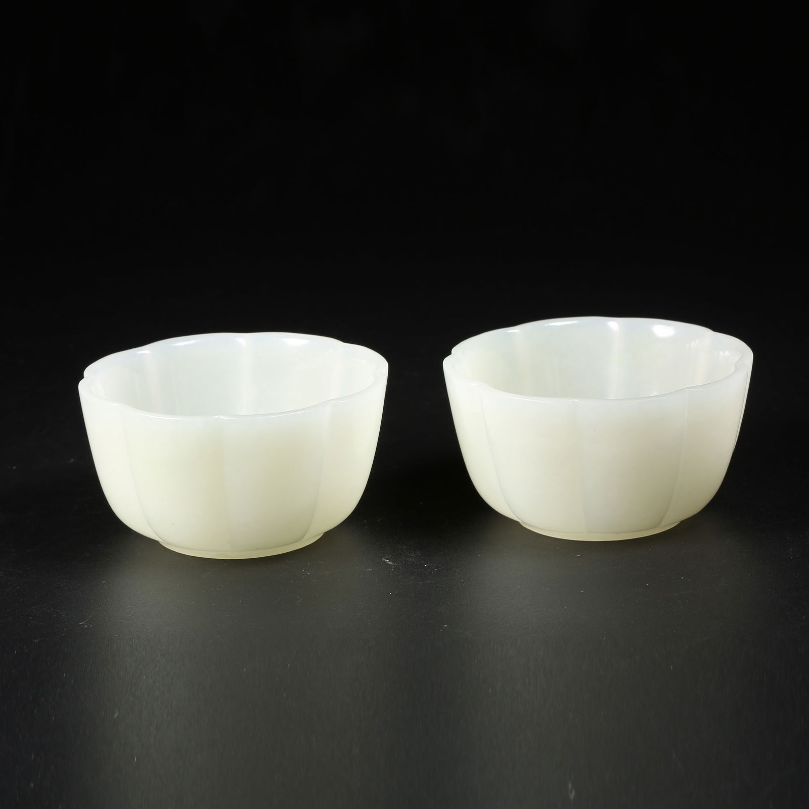 A SET OF HETIAN WHITE JADE FLARED-RIM CUPS (1 of 10)
