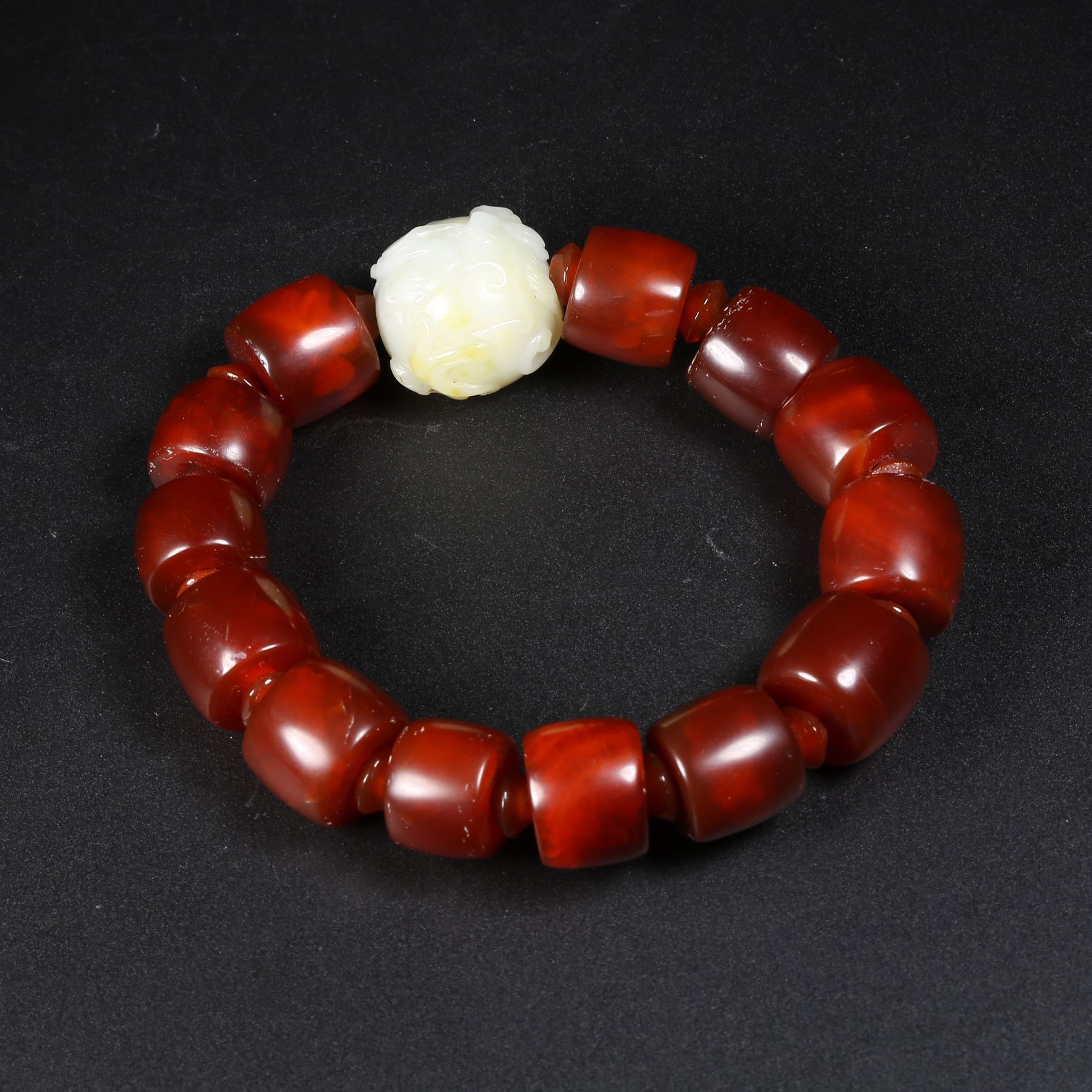 A HETIAN JADE HAND-STRUNG BRACELET WITH CHI-DRAGON PATTERN (1 of 7)