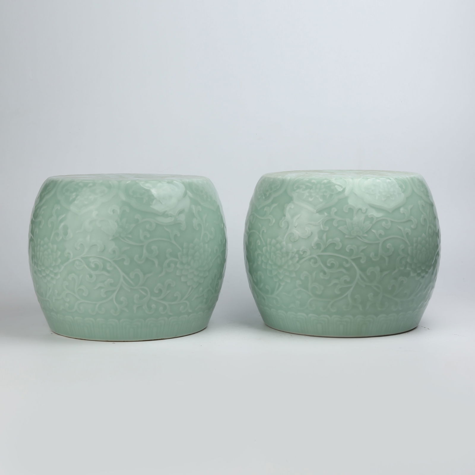 A SET OF POWDER BLUE-GLAZED INTERTWINED FLORAL DRUM STOOLS: Set of Powder Blue-Glazed Intertwined Floral Drum Stools