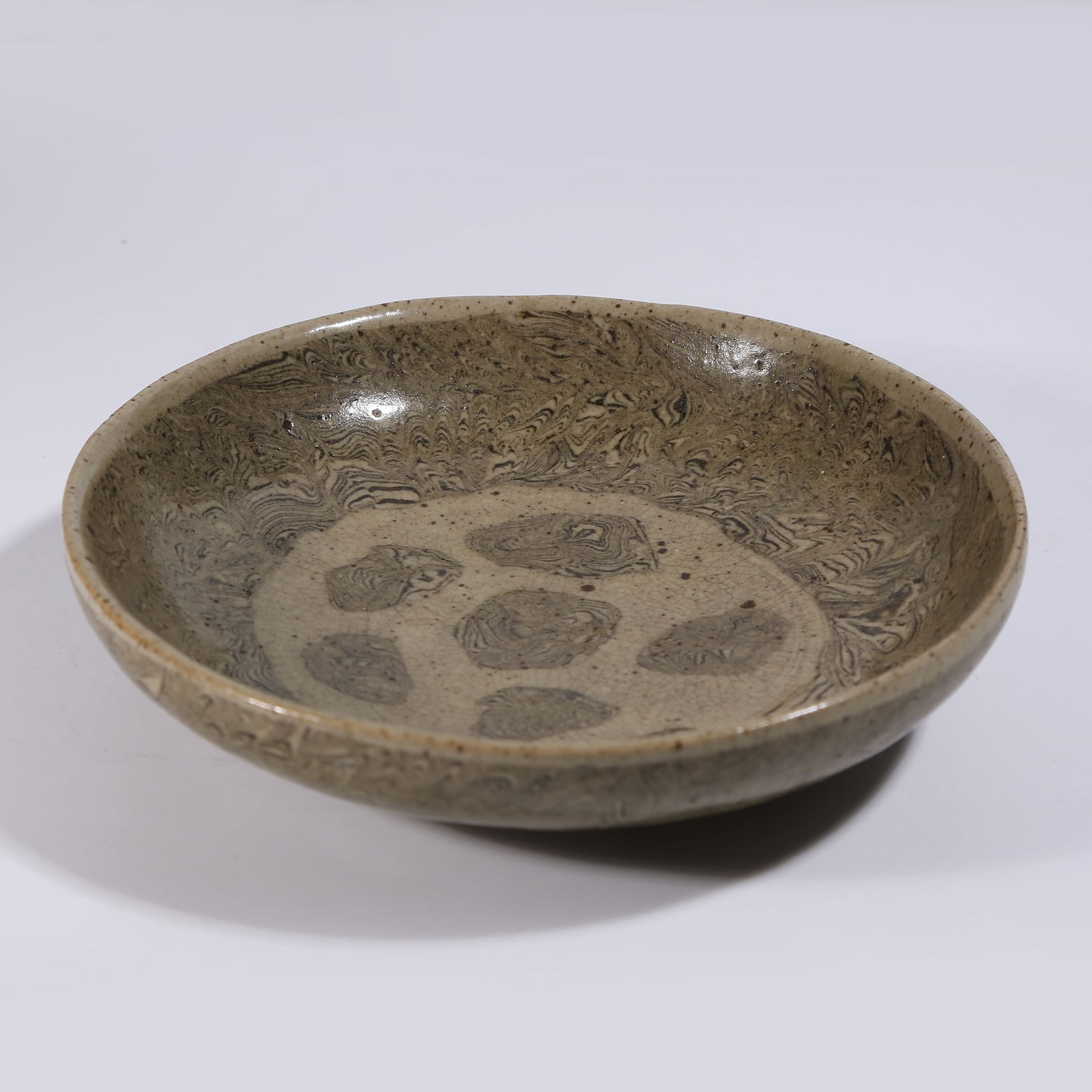 A MARBLED CLAY PLATE: Marbled clay plate