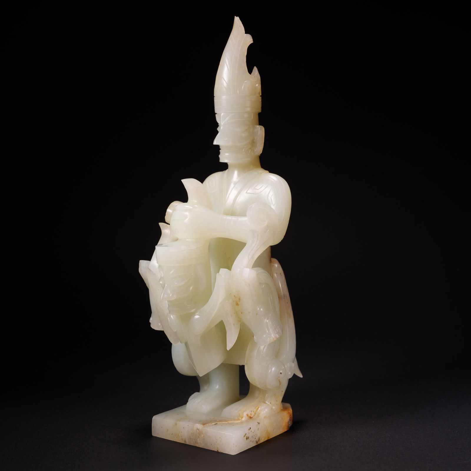 A HETIAN JADE "IMMORTAL GRASPING A DRAGON" ORNAMENT, HAN DYNASTY: Hetian jade "Immortal Grasping a Dragon" ornament, Han Dynasty