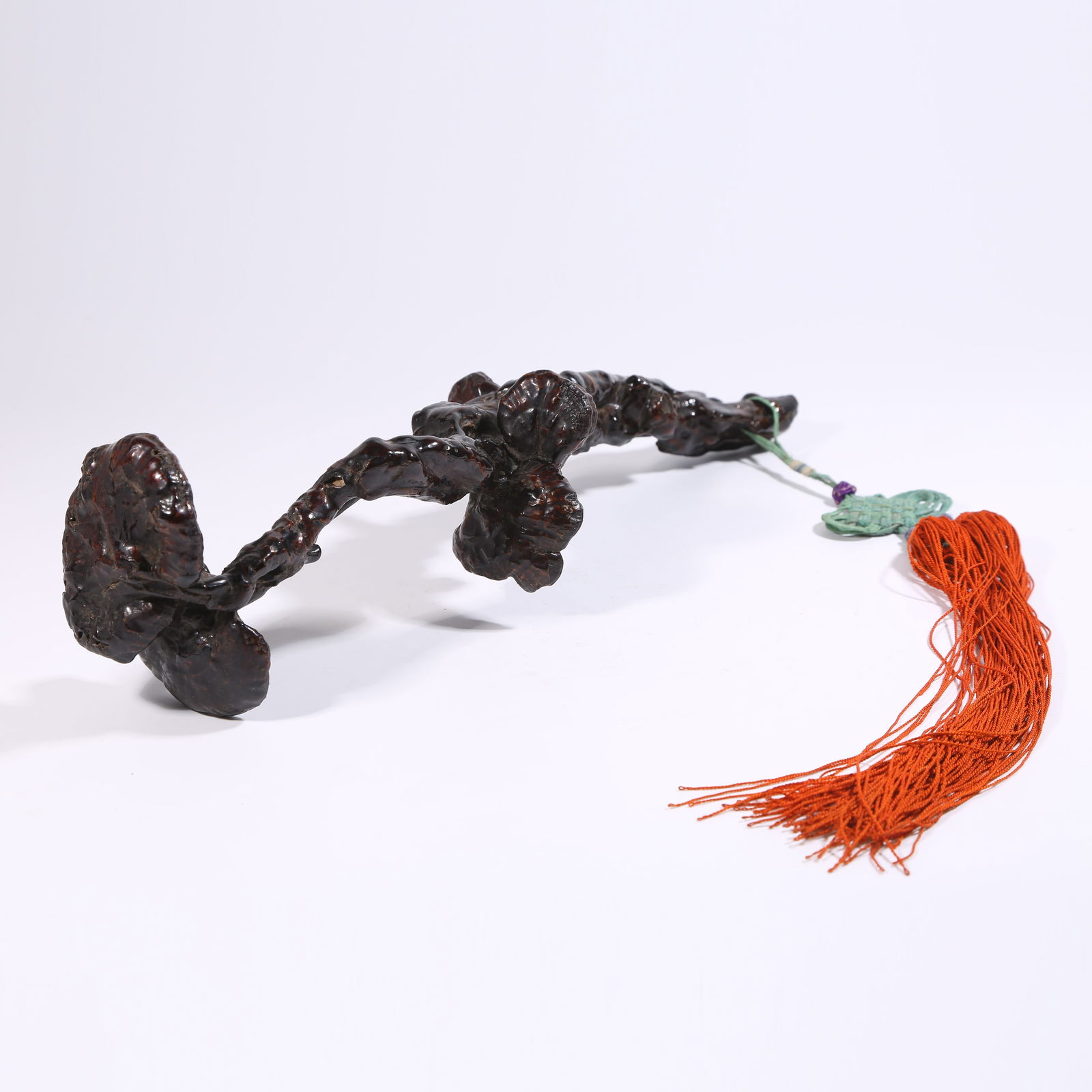 A REDWOOD LACQUER RUYI WITH LINGZHI PATTERN: Redwood lacquer ruyi with lingzhi pattern