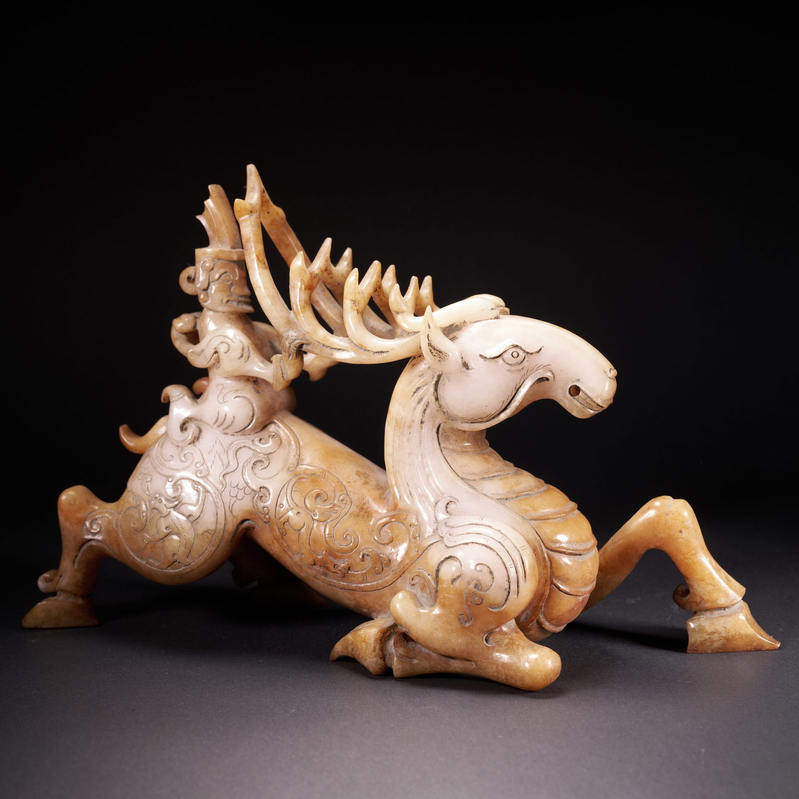 A HETIAN JADE "IMMORTAL RIDING A DEER" ORNAMENT, HAN DYNASTY (1 of 9)