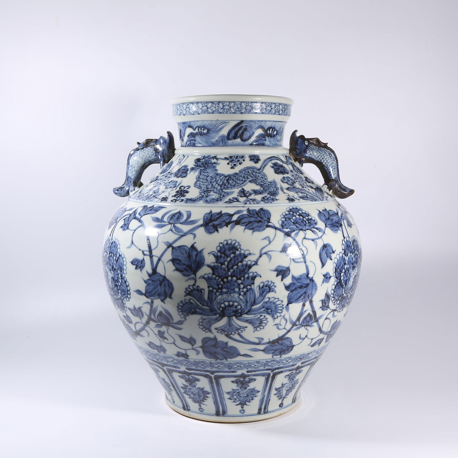 A BLUE-AND-WHITE ZUN WITH INTERTWINING FLORAL SCROLLS AND DRAGON-FISH HANDLES (1 of 9)