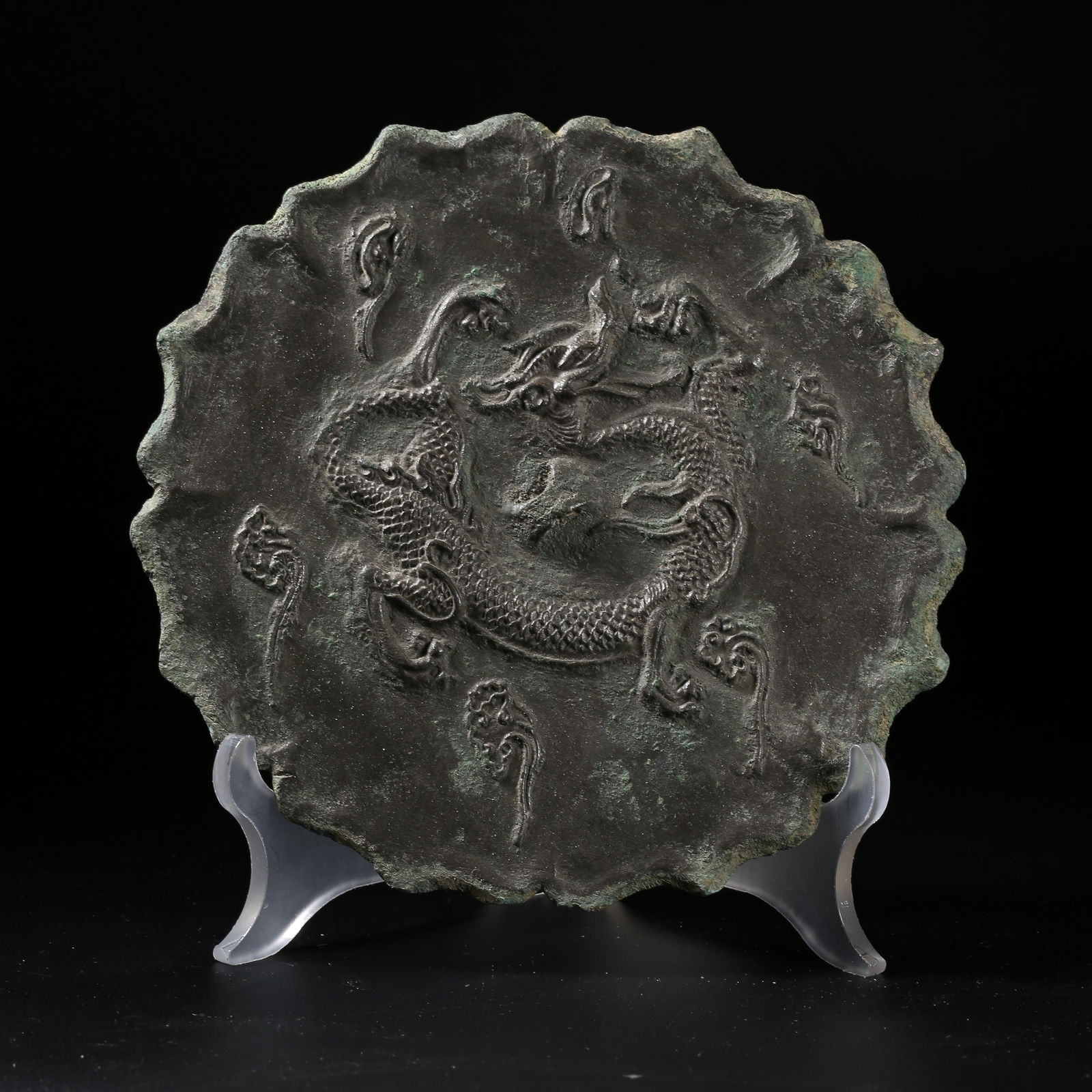A BRONZE MIRROR WITH CLOUD-AND-DRAGON PATTERN AND PETAL-SHAPED RIM (1 of 9)