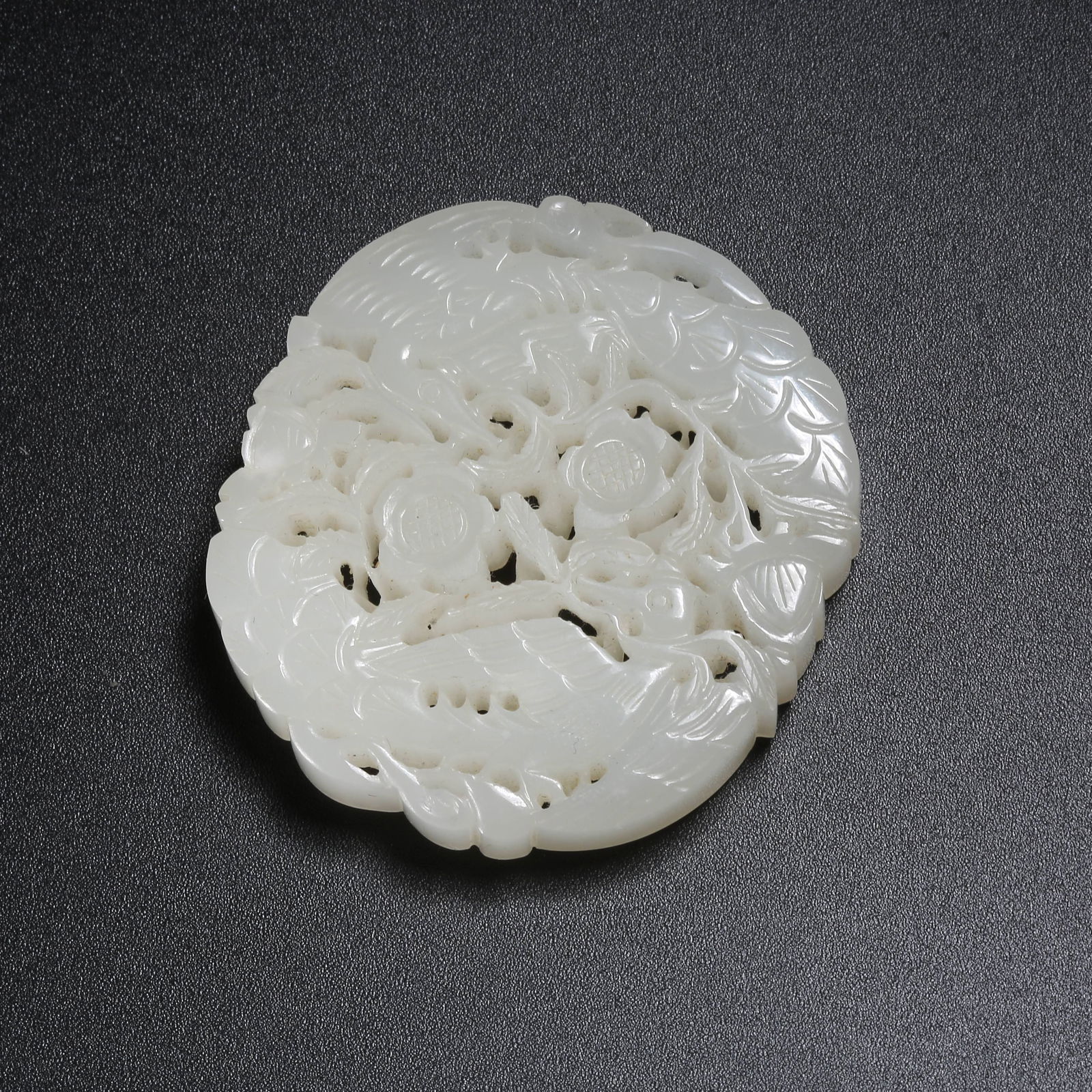 A HETIAN JADE PLAQUE WITH PIERCED FLOWER-AND-PHOENIX PATTERN (1 of 9)