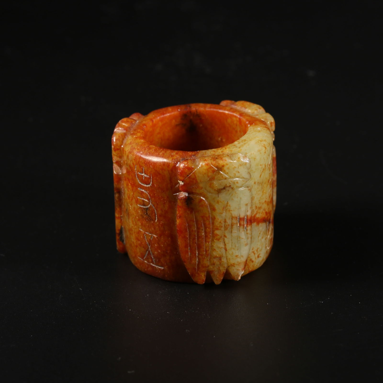 A MIDDLE-PERIOD JADE CICADA-PATTERN THUMB RING (1 of 9)
