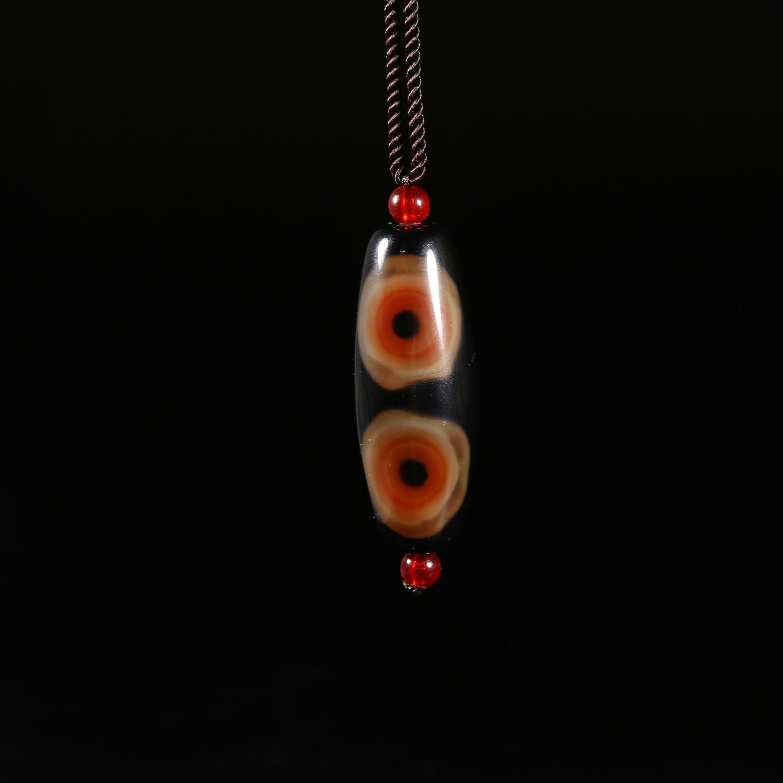 A THREE-EYED AGATE DZI BEAD (1 of 10)