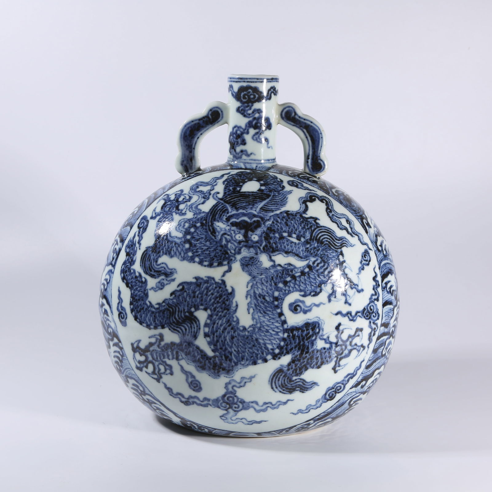 A BLUE-AND-WHITE MOON FLASK WITH DRAGON-AND-WAVES MOTIF AND RIBBON-SHAPED HANDLES (1 of 9)