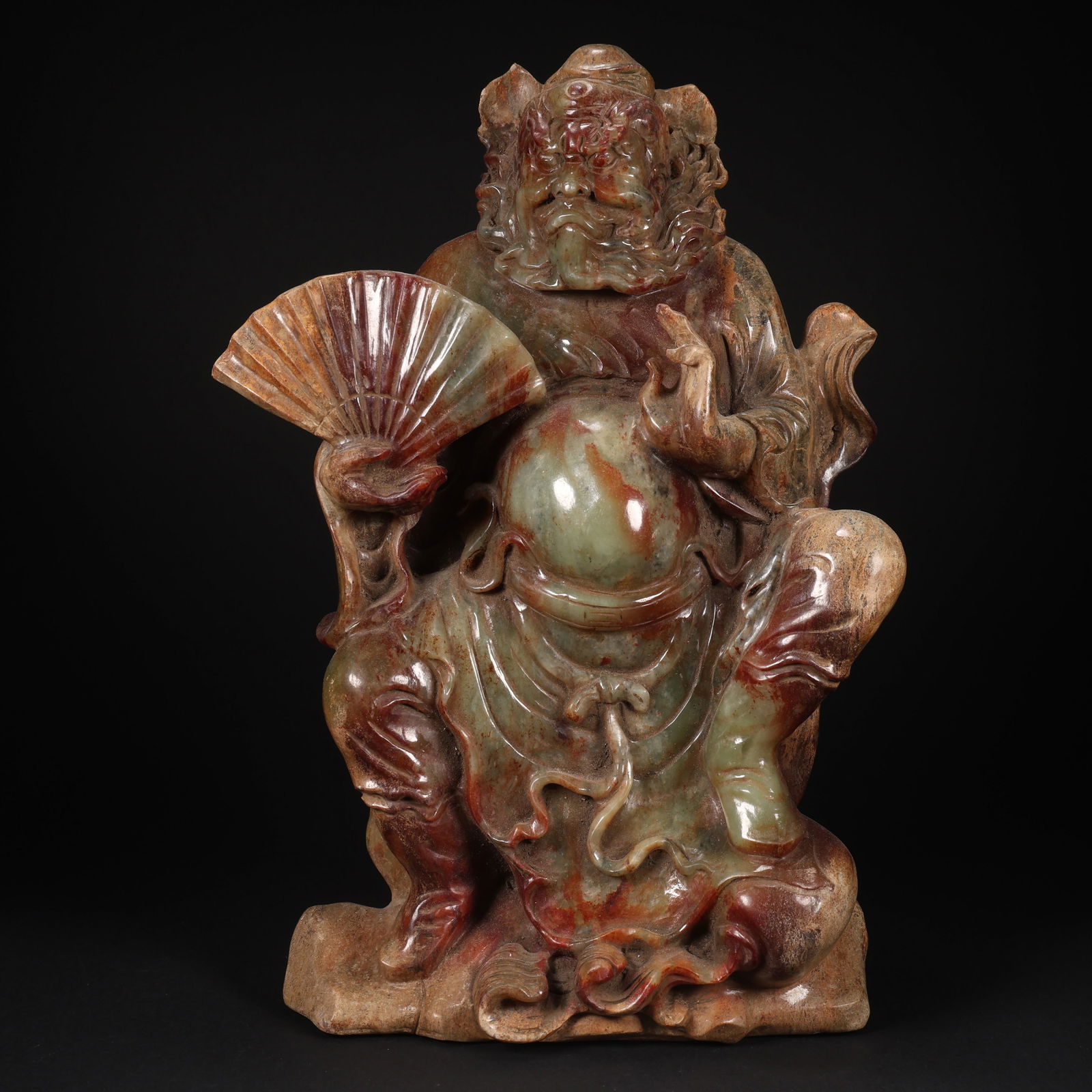 A HETIAN JADE ZHONG KUI HOLDING A FAN DEMON-SUBDUING FIGURINE: Hetian Jade Zhong Kui Holding a Fan Demon-Subduing Figurine