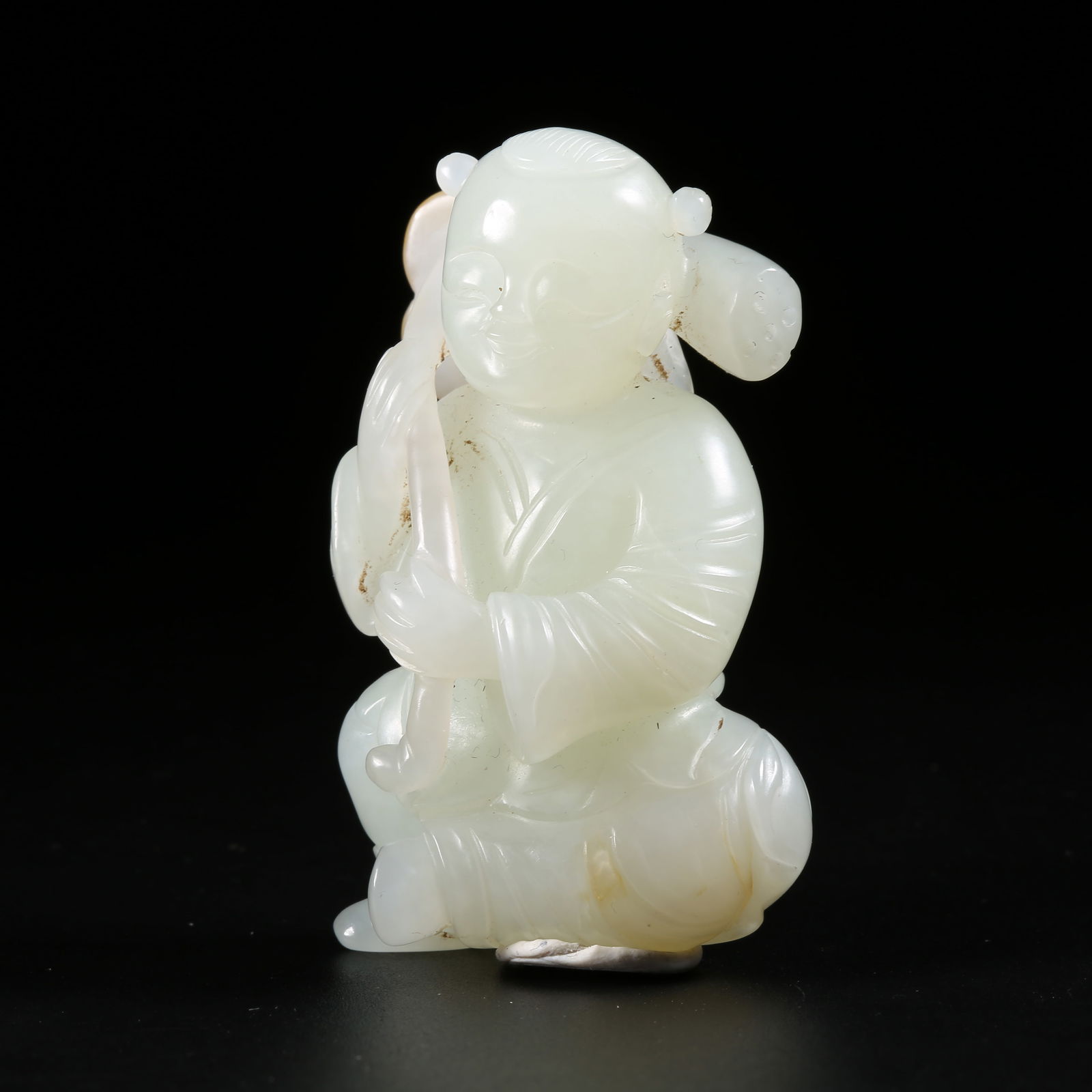 A HETIAN JADE FIGURINE OF A CHILD HOLDING A LOTUS (1 of 8)