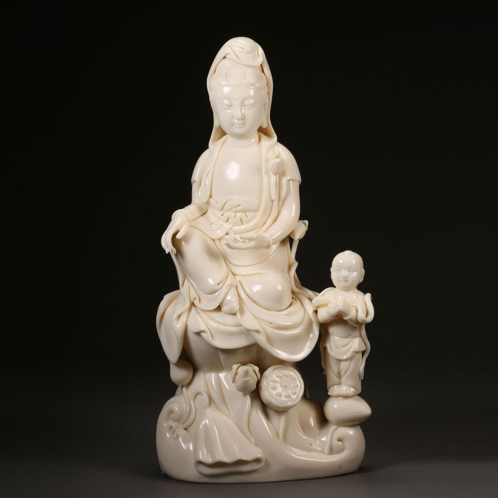 A DEHUA WHITE PORCELAIN STATUE OF GUANYIN BESTOWING CHILDREN (1 of 9)