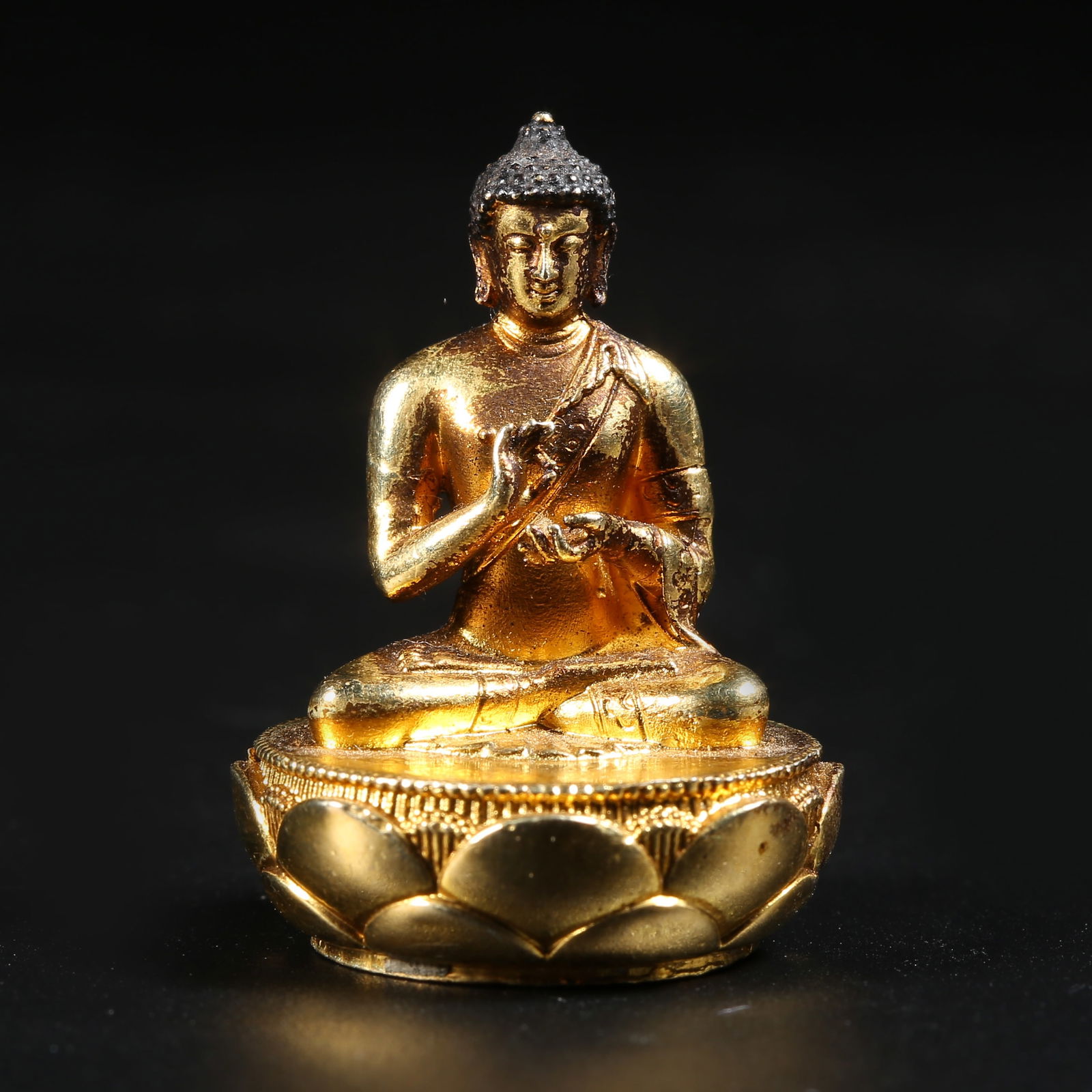A GILT-BRONZE MINIATURE SHAKYAMUNI (1 of 8)