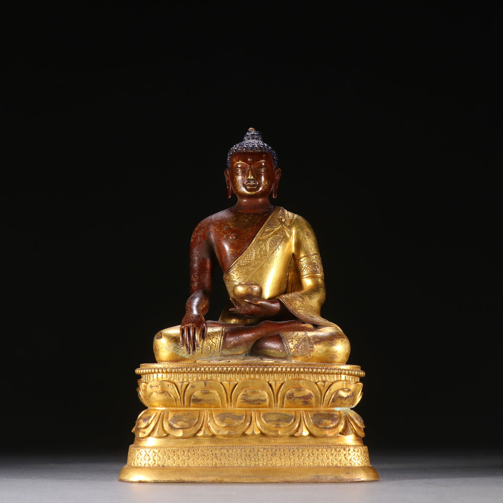 A GILDED BRONZE MEDICINE BUDDHA: Gilded Bronze Medicine Buddha