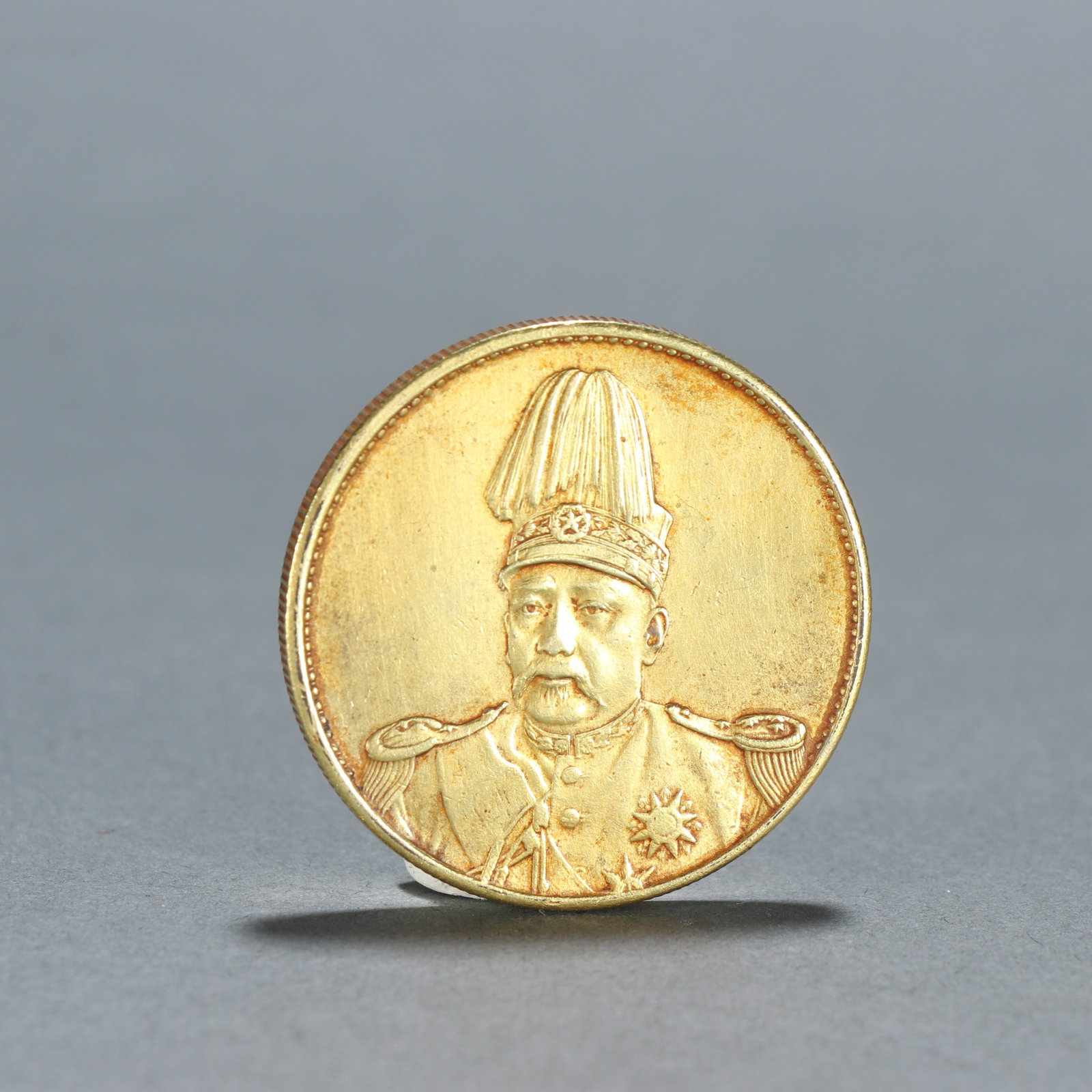 A SILVER GILDED COIN: Silver Gilded Coin