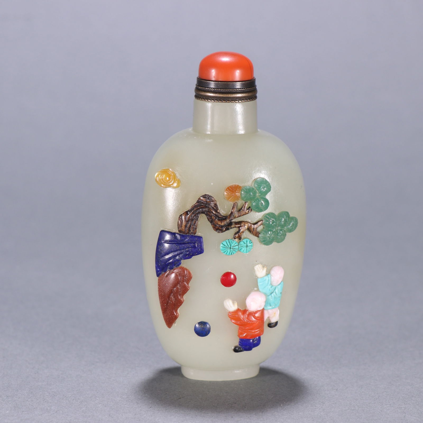 A HETIAN JADE SNUFF BOTTLE INLAID WITH PRECIOUS MATERIALS DEPICTING CHILDREN AT PLAY (1 of 9)