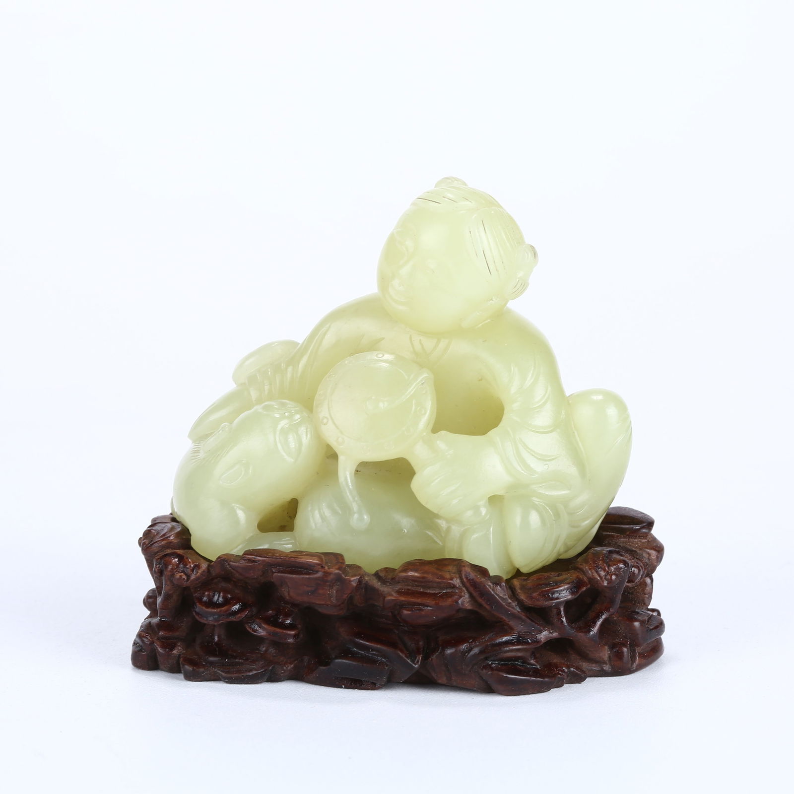 A HETIAN YELLOW JADE FIGURINE OF A BOY: Hetian yellow jade figurine of a boy