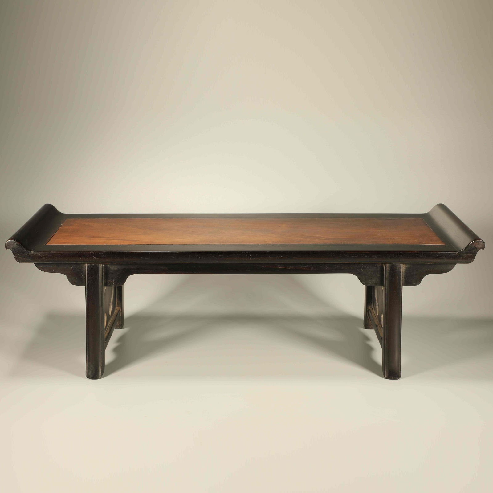 A ZITAN INLAID HUANGHUALI LOW TABLE WITH RAISED CORNERS: Zitan inlaid Huanghuali low table with raised corners