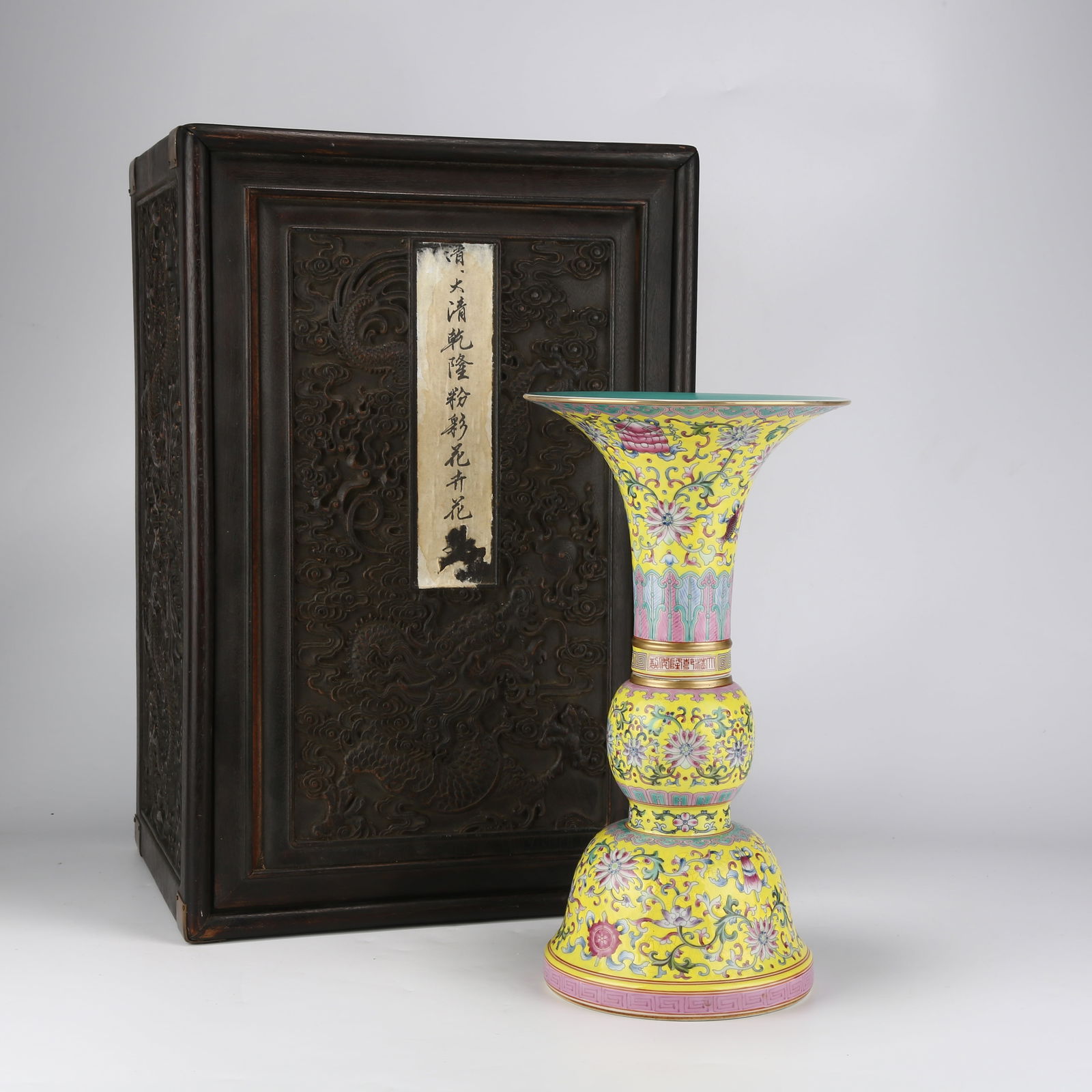 A YELLOW-GROUND FAMILLE-ROSE FLOWER VASE WITH EIGHT AUSPICIOUS SYMBOLS AND WESTERN LOTUS DESIGN: Yellow-Ground Famille-Rose Flower Vase with Eight Auspicious Symbols and Western Lotus Design