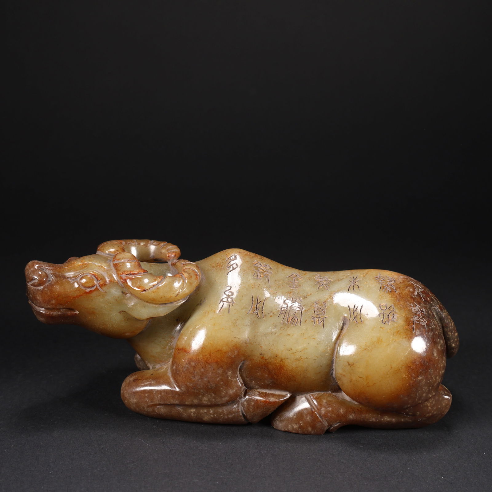 A HETIAN JADE INSCRIBED OX WITH POETRY AND CALLIGRAPHY: Hetian Jade Inscribed Ox with Poetry and Calligraphy