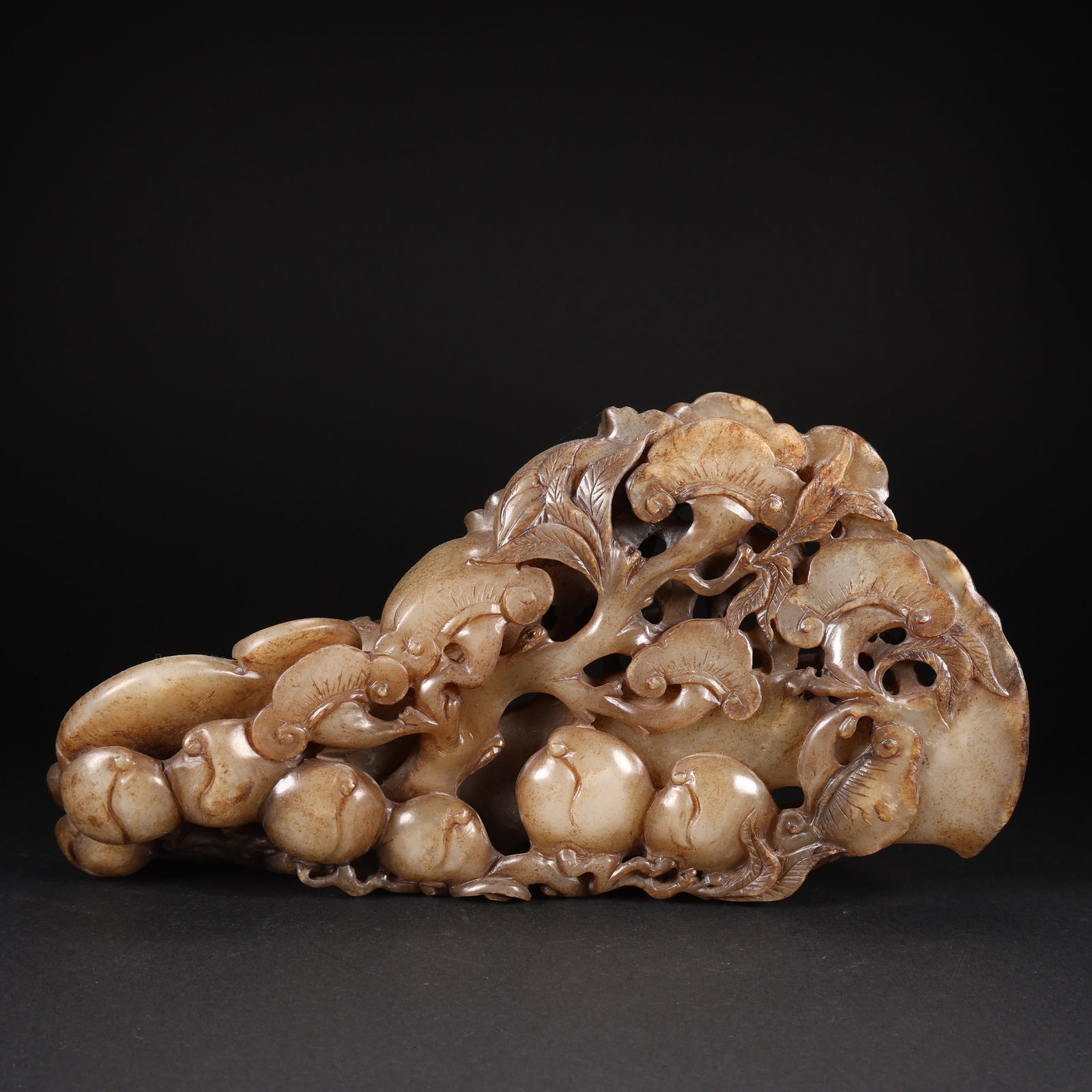 A HETIAN JADE FIGURINE OF LONGEVITY PEACHES, LINGZHI MUSHROOMS, AND RUYI SCEPTER (1 of 9)
