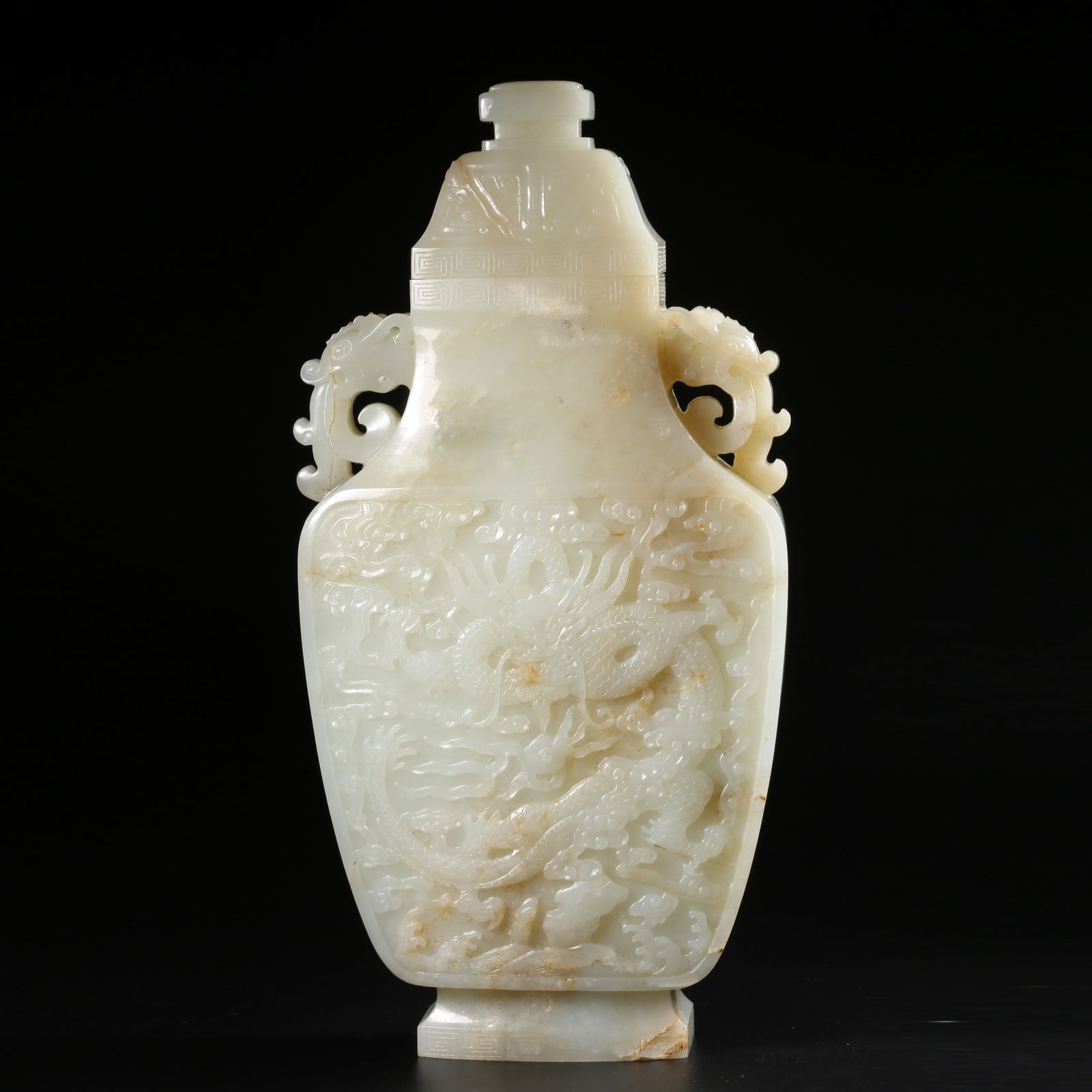 A HETIAN WHITE JADE CLOUD-AND-DRAGON PATTERNED DRAGON-EARED COVERED VASE (1 of 10)