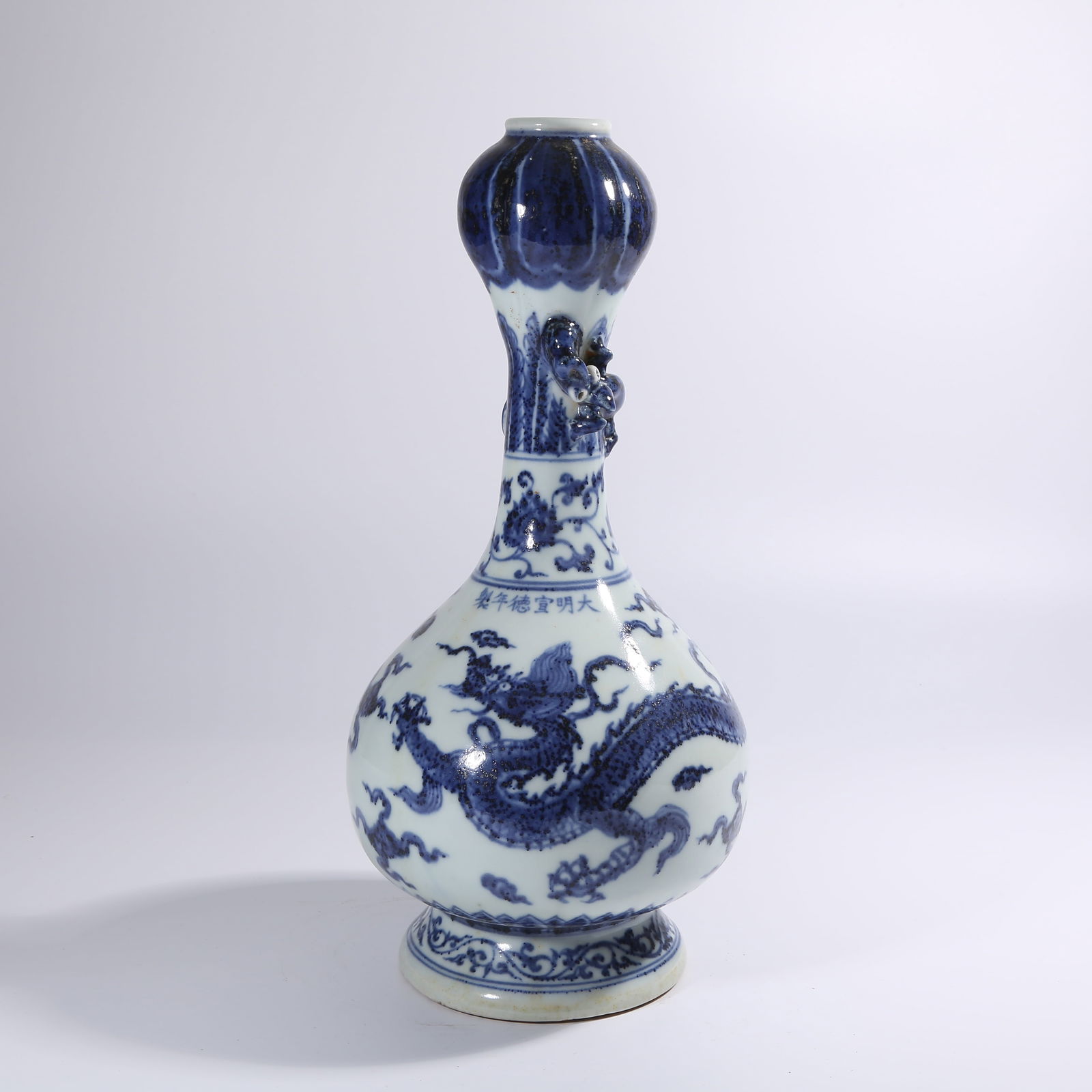 A BLUE AND WHITE GARLIC-FORM VASE WITH CLOUD AND DRAGON MOTIF (1 of 9)
