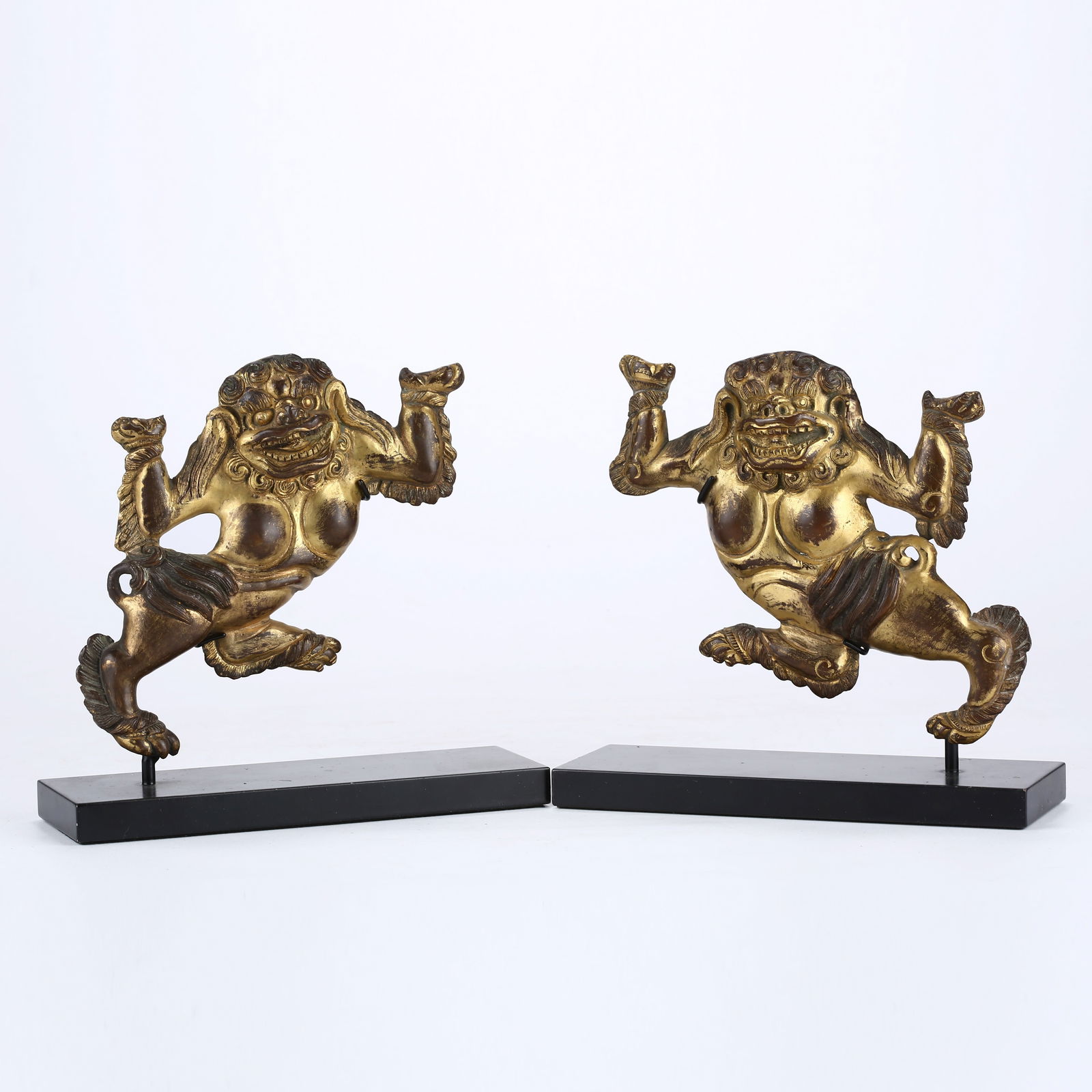 A SET OF GILT BRONZE DHARMA PROTECTOR LIONS: Set of Gilt Bronze Dharma Protector Lions