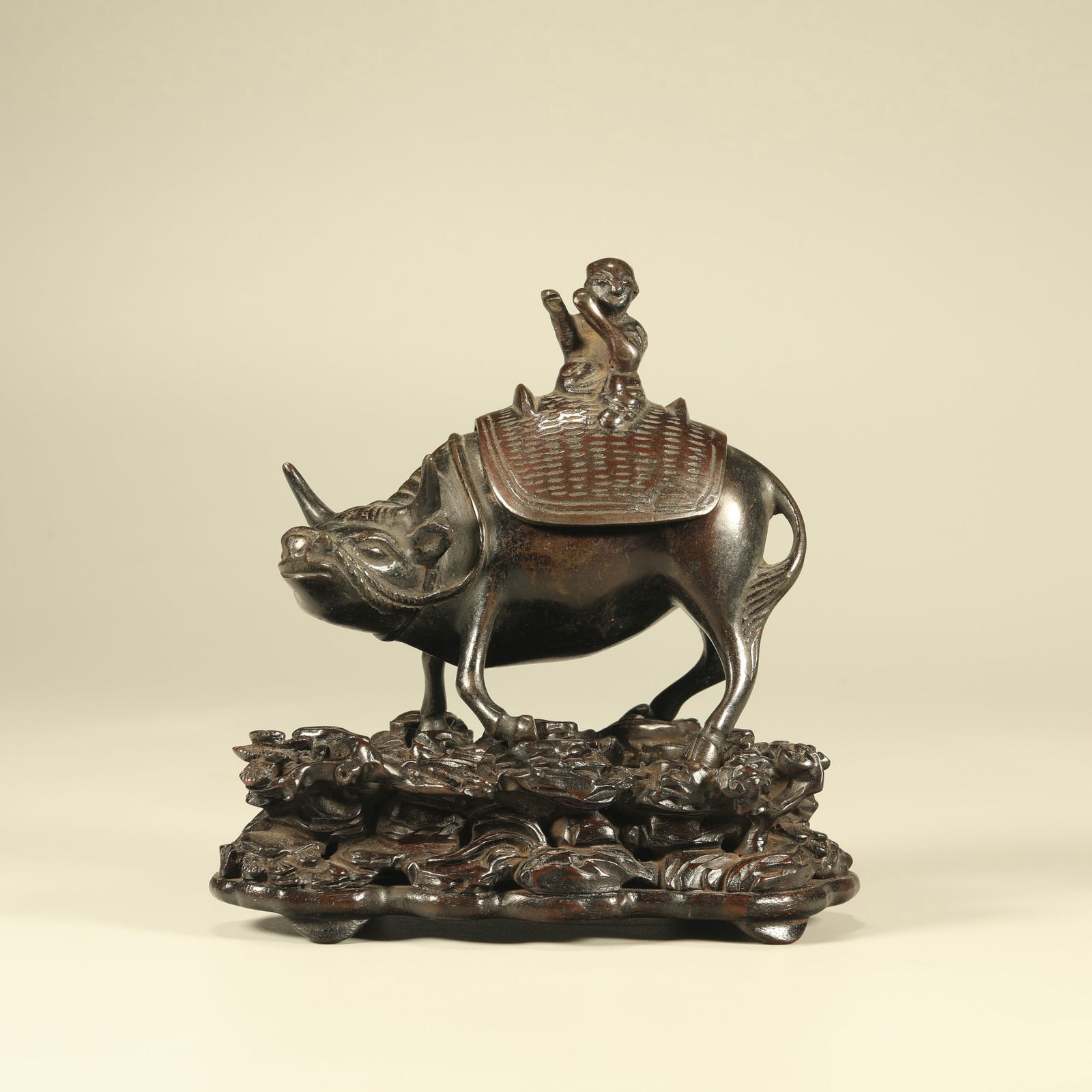 A BRONZE INCENSE BURNER IN THE FORM OF A BOY RIDING AN OX (1 of 7)