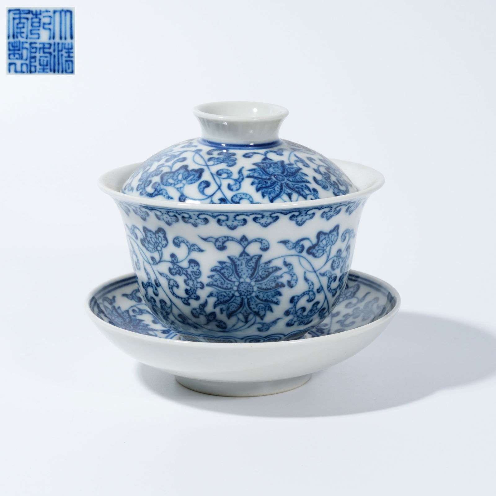 A BLUE-AND-WHITE TEA CUP WITH SCROLLING FLORAL DECORATION (1 of 9)