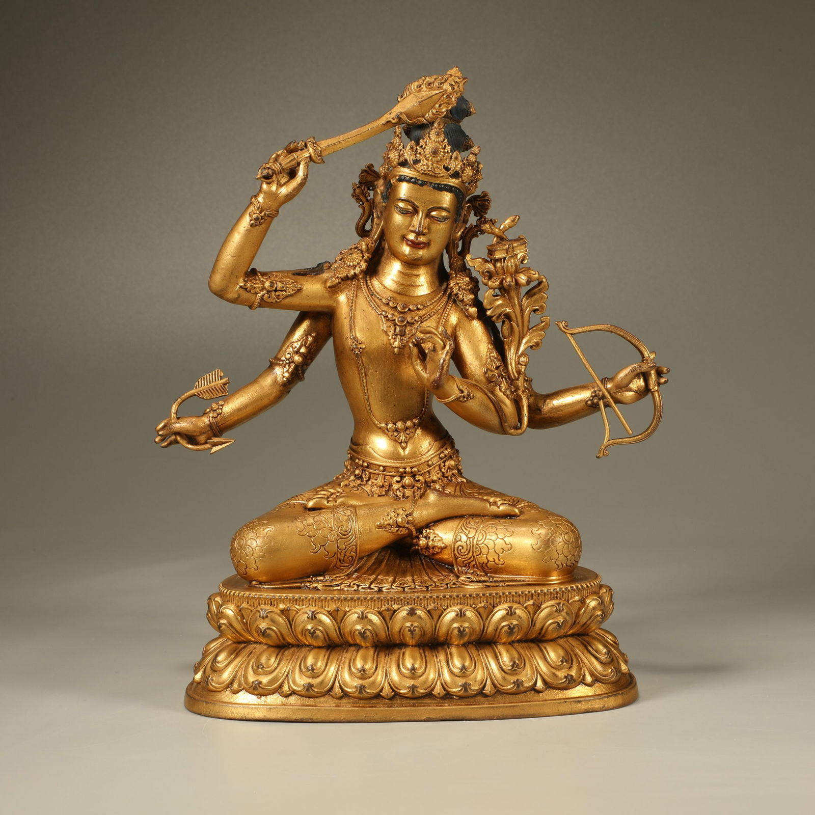 A GILT-BRONZE FIGURE OF MANJUSHRI WITH FOUR ARMS (1 of 7)